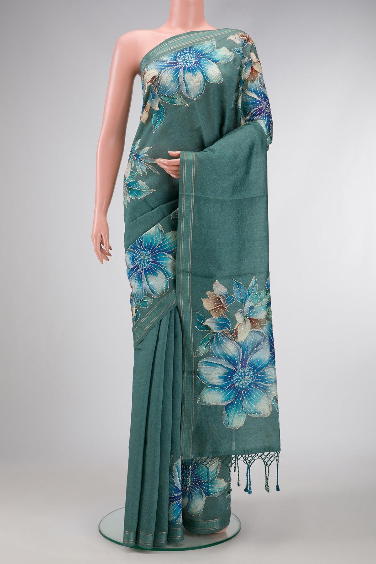 Green Dual Tone Tussar Silk Saree with Embroidery on the body and Zari Border.  displayed on a mannequin