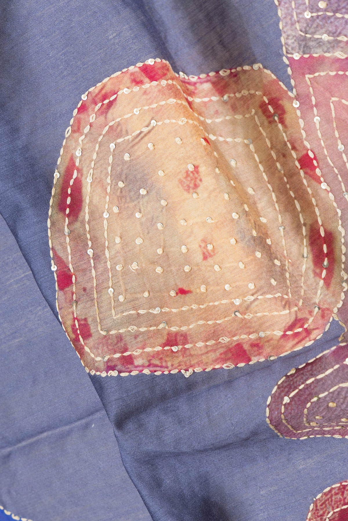 Close up of Grey Dual Tone Tussar Silk Saree with Embroidery on the body and Zari And Thread Border.  displaying folds