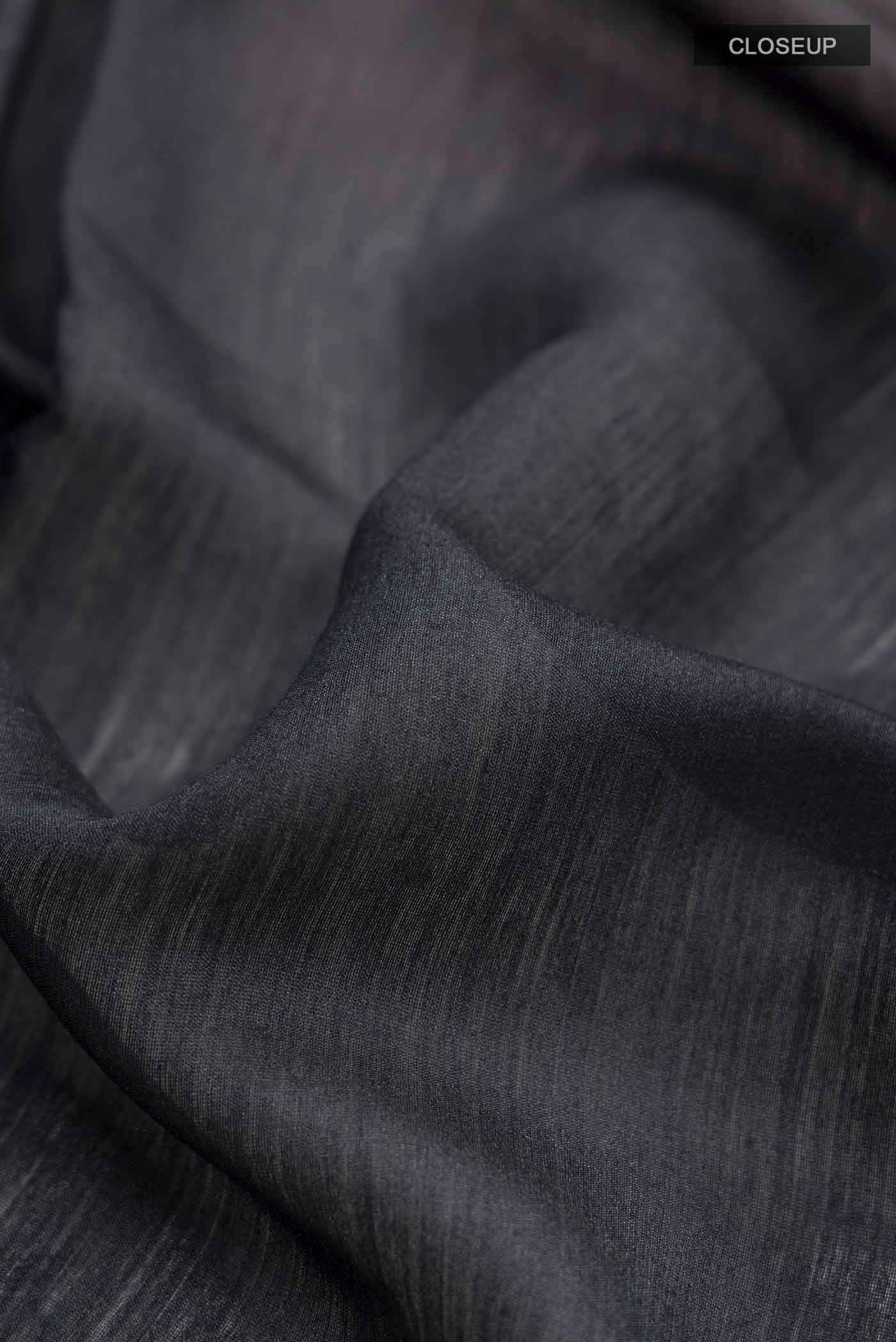 Close up of Black Bhagalpuri Tussar Silk Saree with Embroidery on the body and Zari Border displaying folds