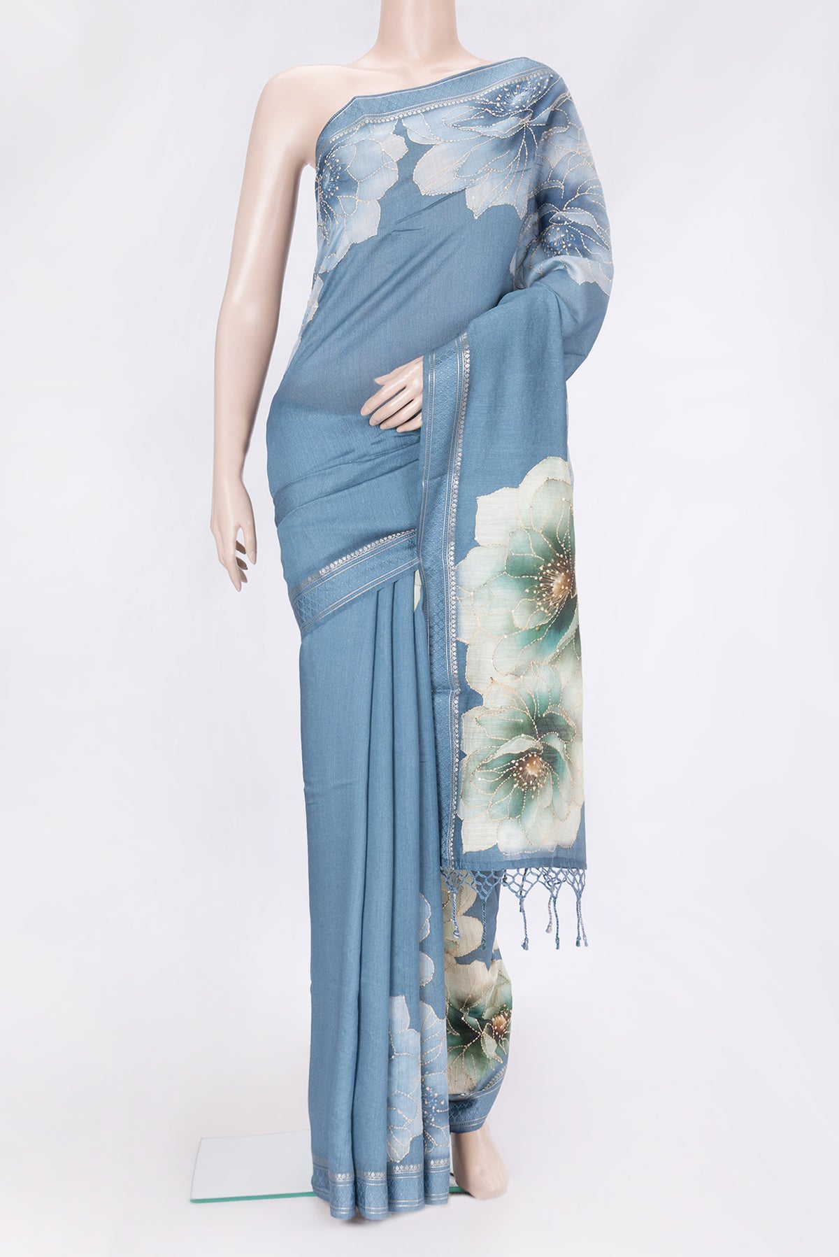 Light Blue Dual Tone Tussar Silk Saree with Embroidery on the body and Zari And Thread Border.  displayed on a mannequin