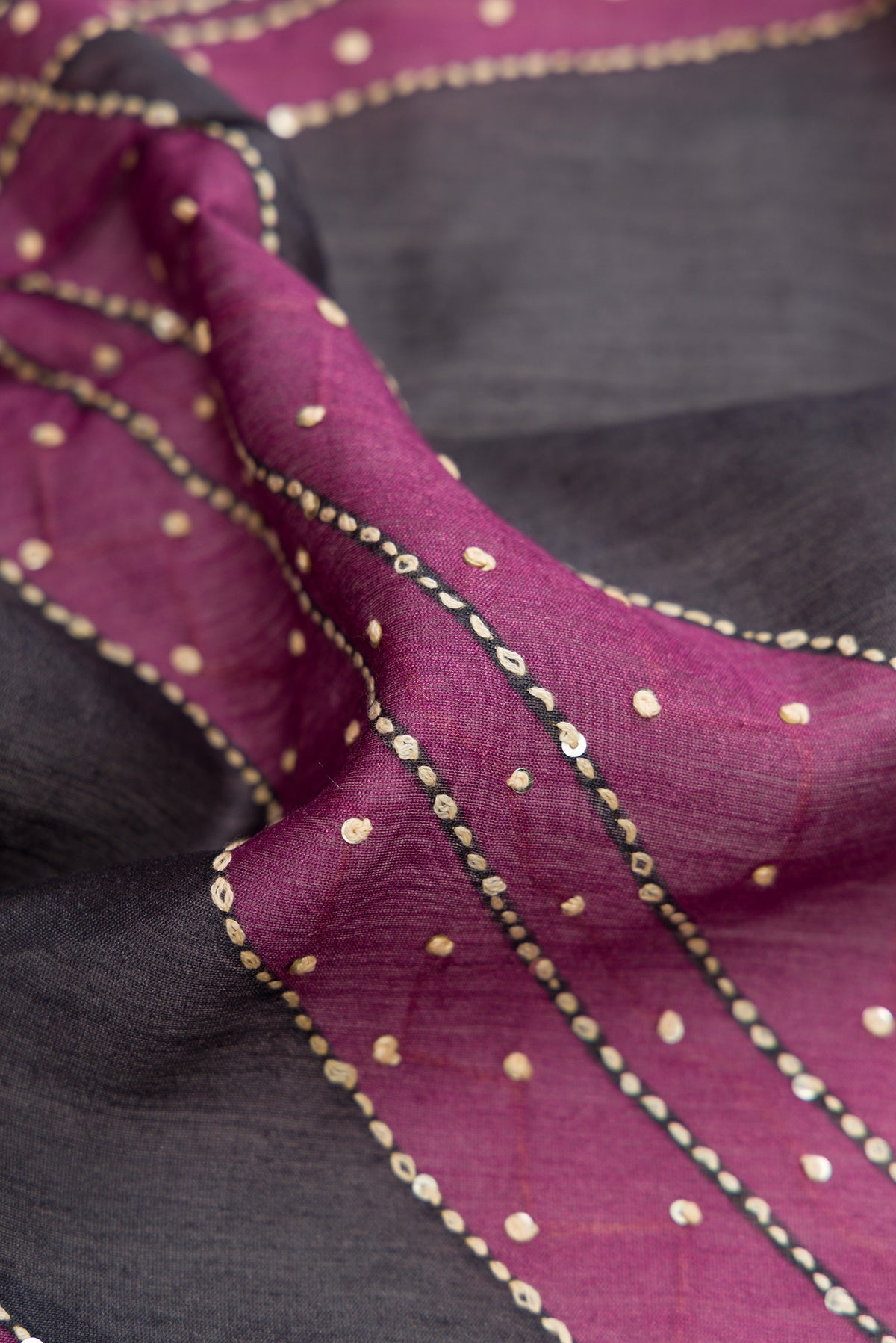 Close up of Grey Tussar Silk Saree with Embroidery on the body and Zari Border.  displaying folds