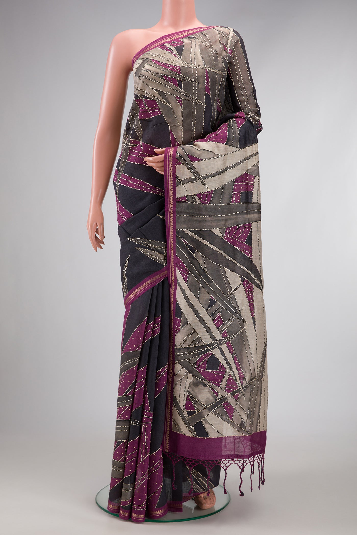 Grey Tussar Silk Saree with Embroidery on the body and Zari Border.  displayed on a mannequin