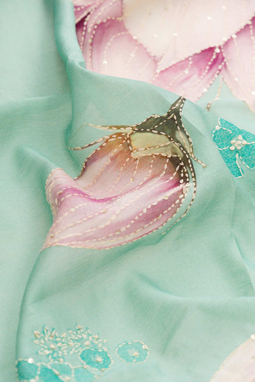 Close up of Sea Green Dual Tone Tussar Silk Saree with Printed design on the body and Zari And Thread Border displaying folds