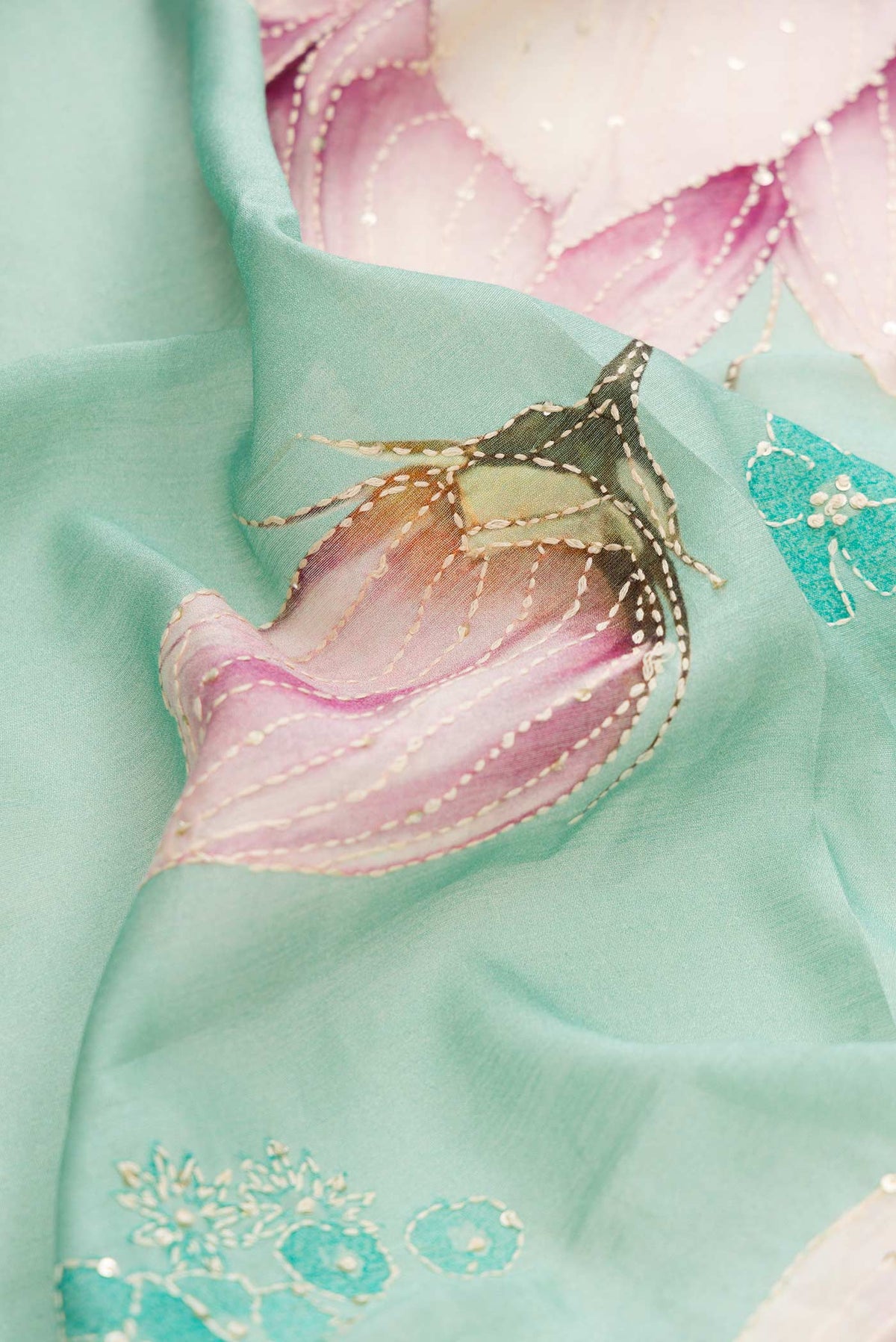 Close up of Sea Green Dual Tone Tussar Silk Saree with Printed design on the body and Zari And Thread Border displaying folds