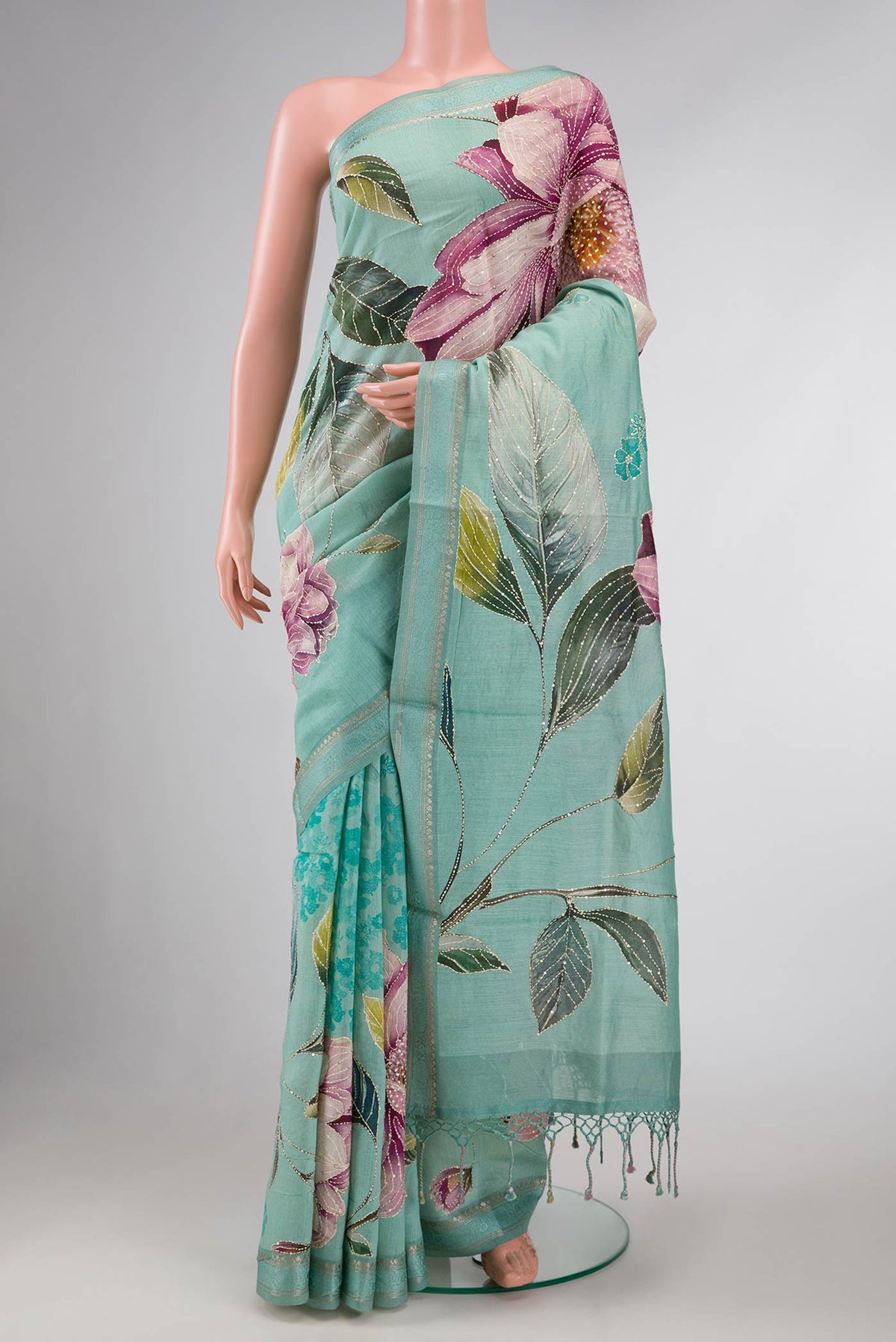 Sea Green Dual Tone Tussar Silk Saree with Printed design on the body and Zari And Thread Border displayed on a mannequin