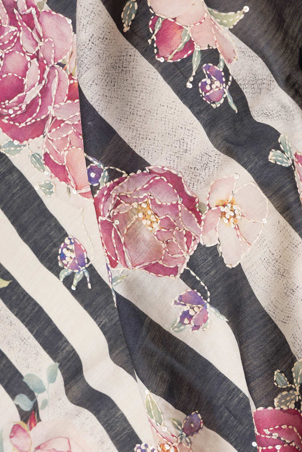 Close up of Black Dual Tone Tussar Silk Saree with Embroidery on the body and Zari And Thread Border.  displaying folds