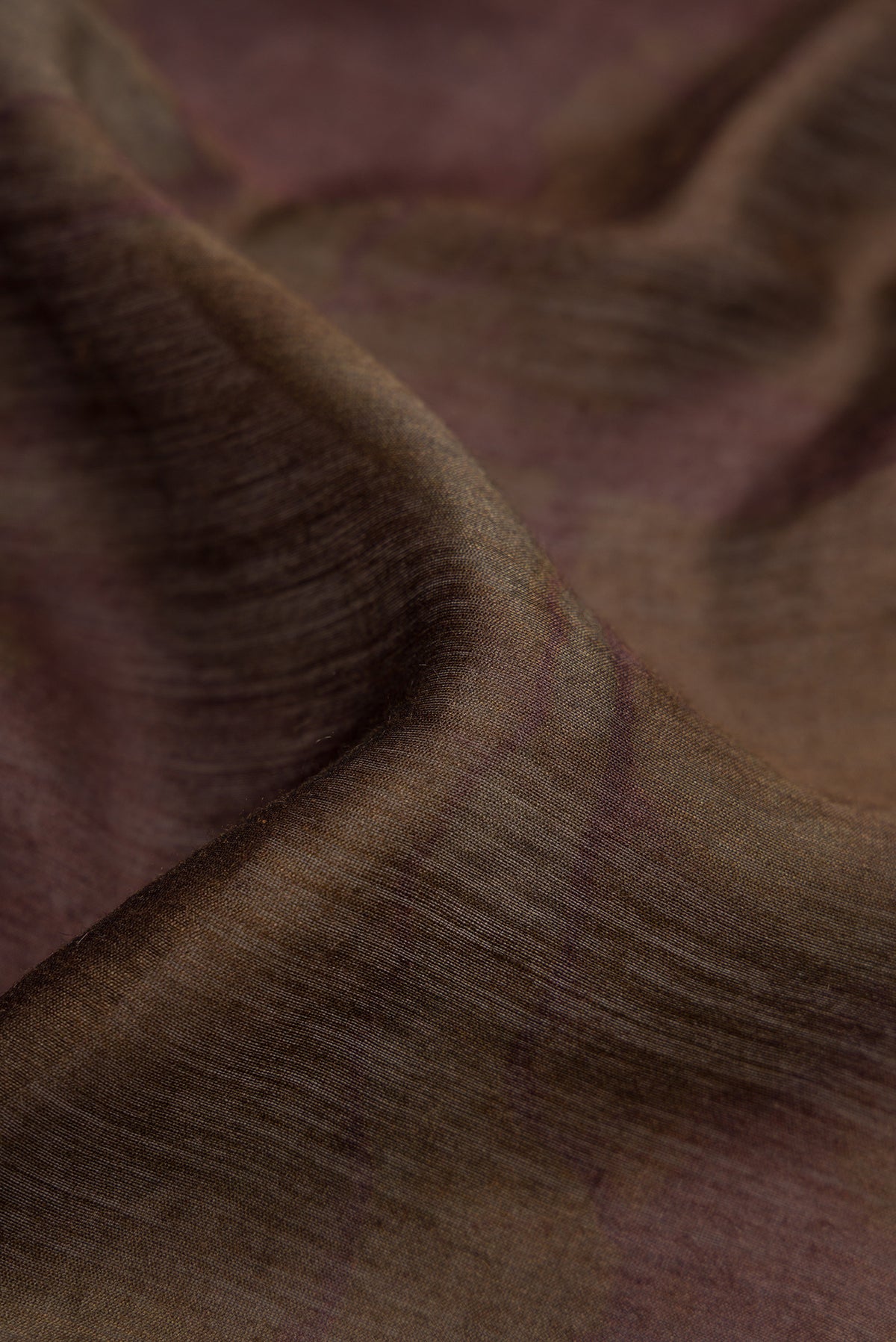 Close up of Brown Tussar Silk Saree with Printed design on the body and Zari Border.  displaying folds