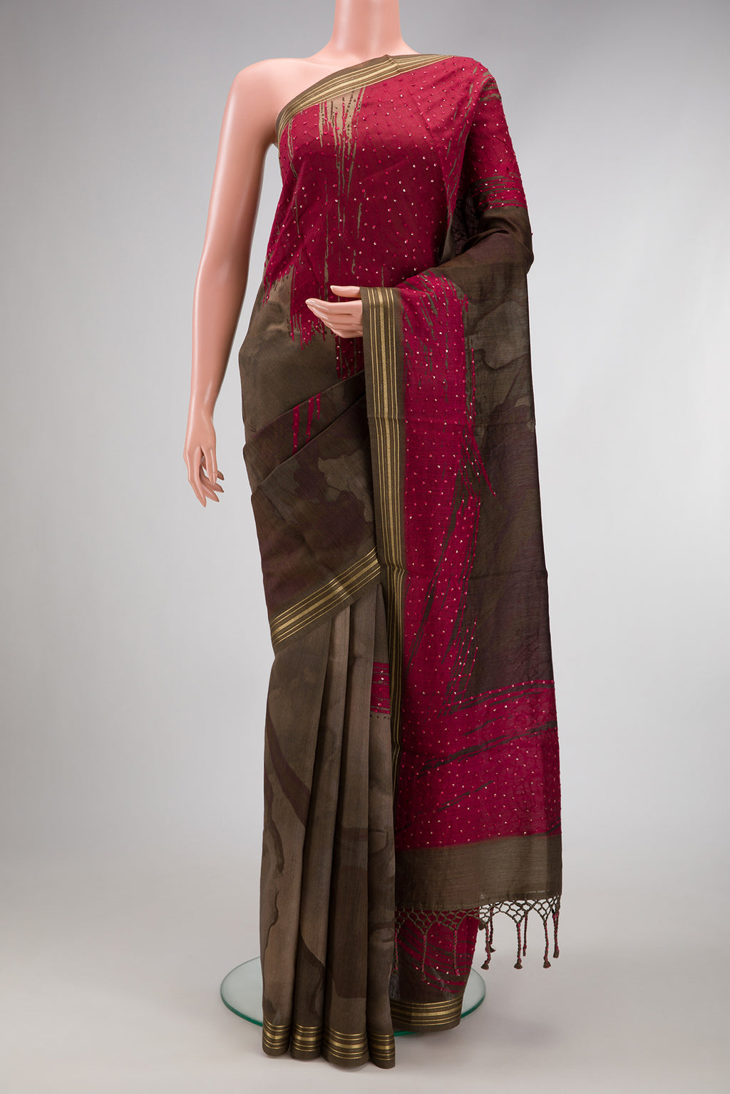 Brown Tussar Silk Saree with Printed design on the body and Zari Border.  displayed on a mannequin