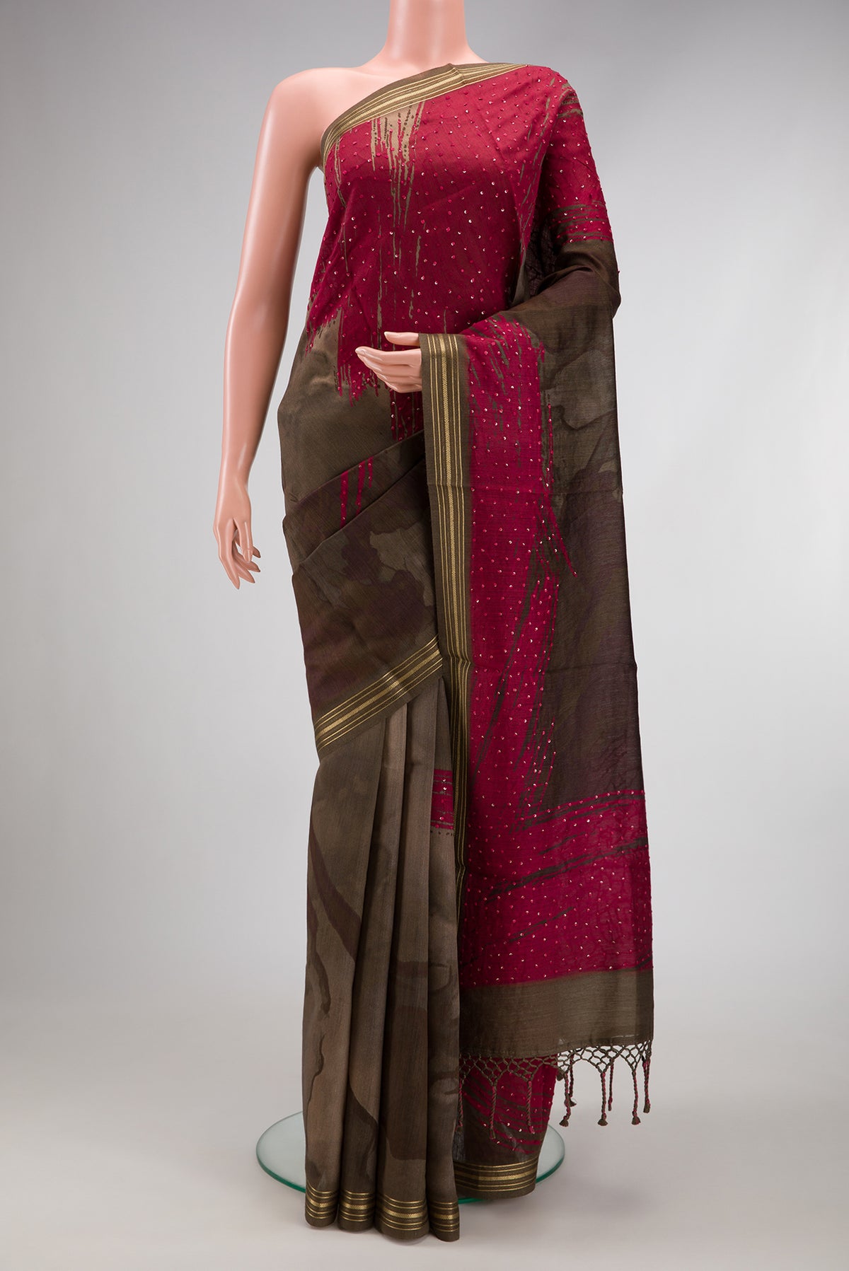 Brown Tussar Silk Saree with Printed design on the body and Zari Border.  displayed on a mannequin