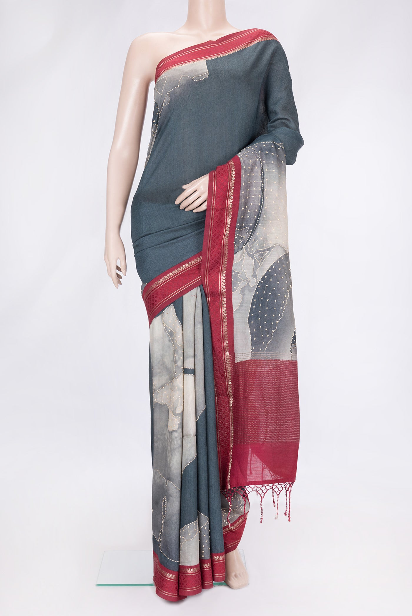 Grey Dual Tone Tussar Silk Saree with Embroidery on the body and Zari And Thread Border.  displayed on a mannequin