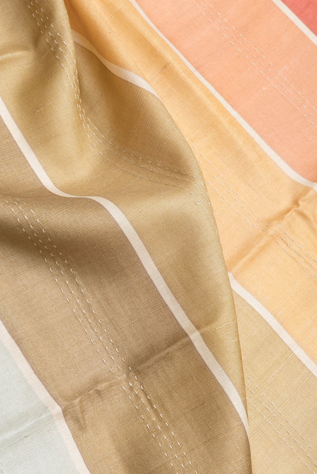 Close up of Grey,Pink and Mustard Color Tussar Silk Saree with Embroidery on the body and Embroidery Border.  displaying folds