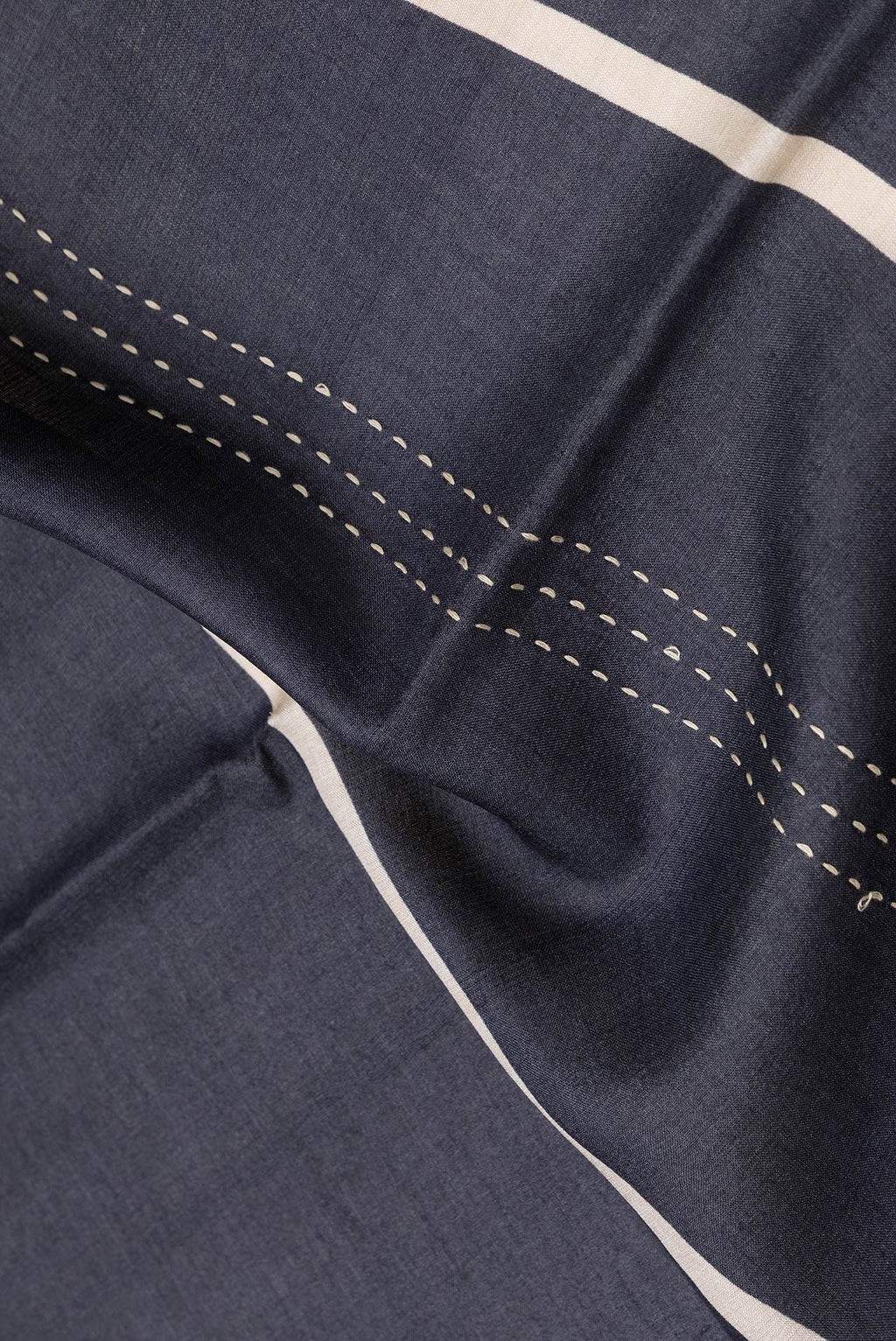 Close up of Black Dual Tone Tussar Silk Saree with Embroidery on the body and Embroidery Border.  displaying folds