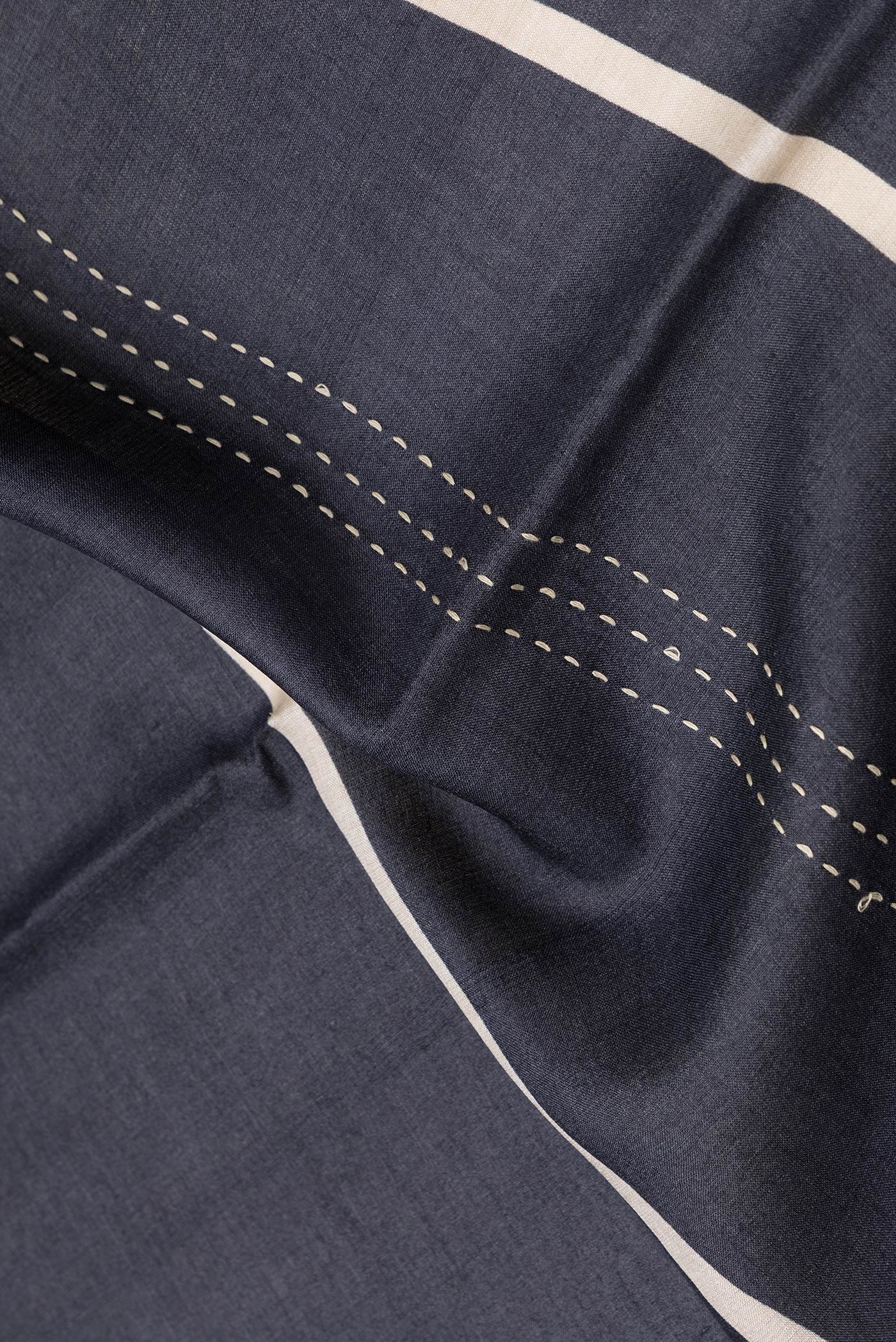 Close up of Black Dual Tone Tussar Silk Saree with Embroidery on the body and Embroidery Border.  displaying folds