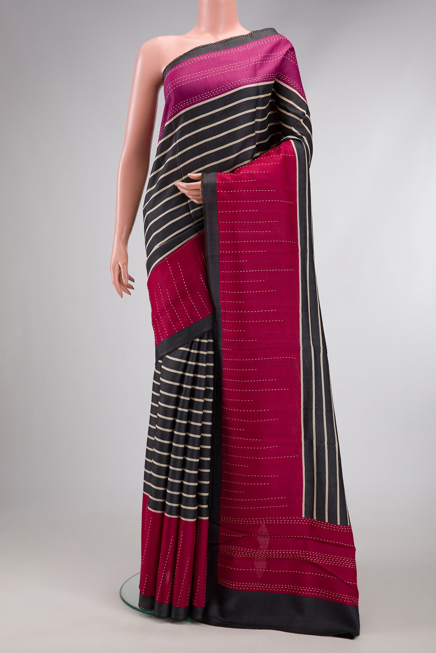 Black Dual Tone Tussar Silk Saree with Stripes on the body and Embroidery Border.  displayed on a mannequin