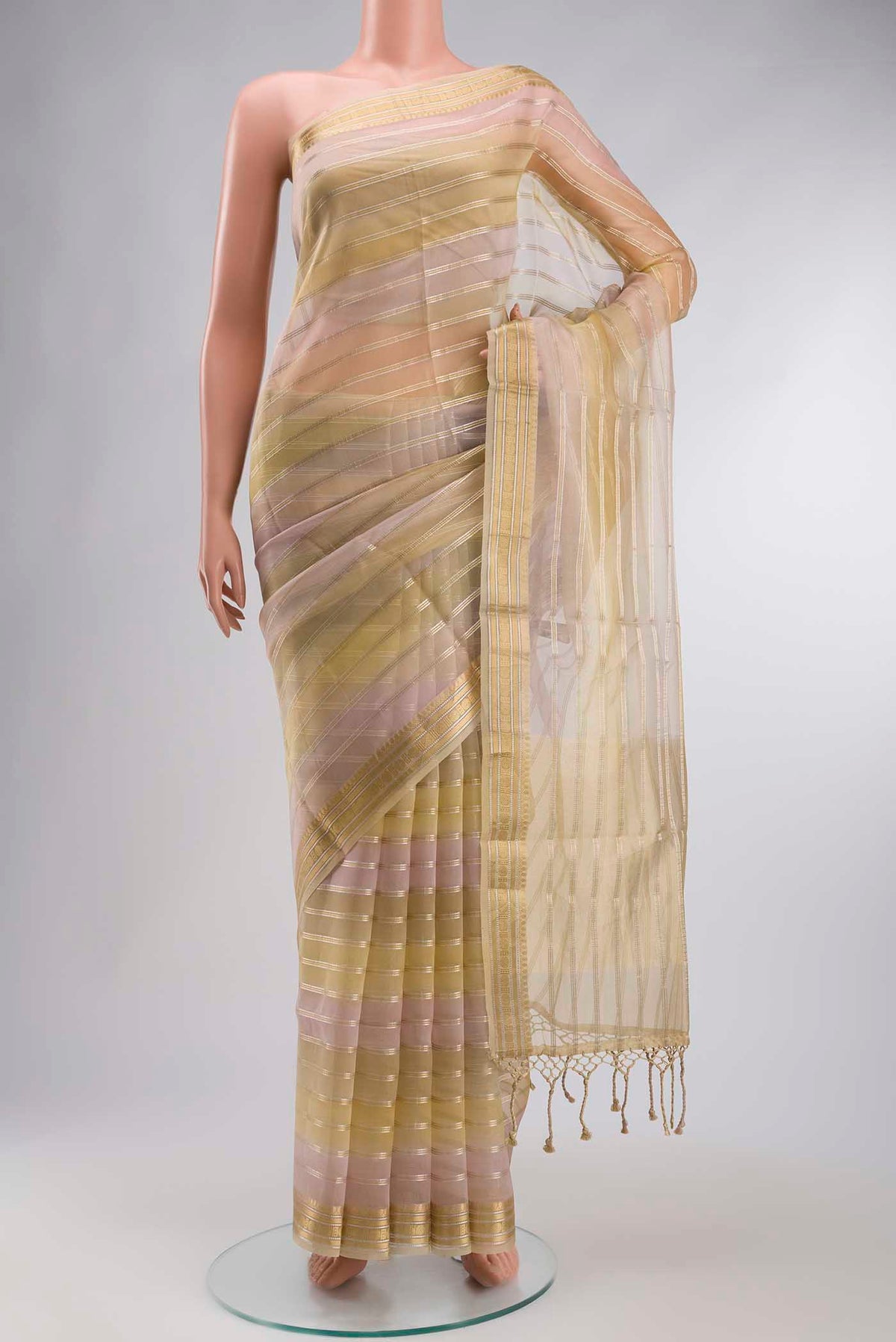 Beige Organza Silk Saree with Stripes on the body and Zari Border displayed on a mannequin