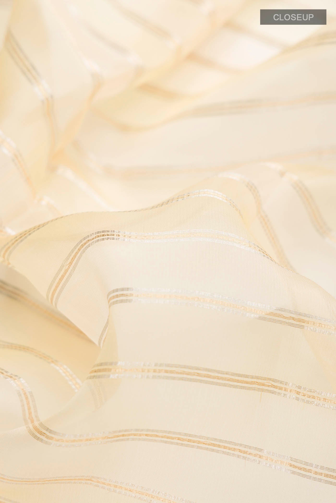 Close up of Sandal Organza Silk Saree with Stripes on the body and Zari Border displaying folds