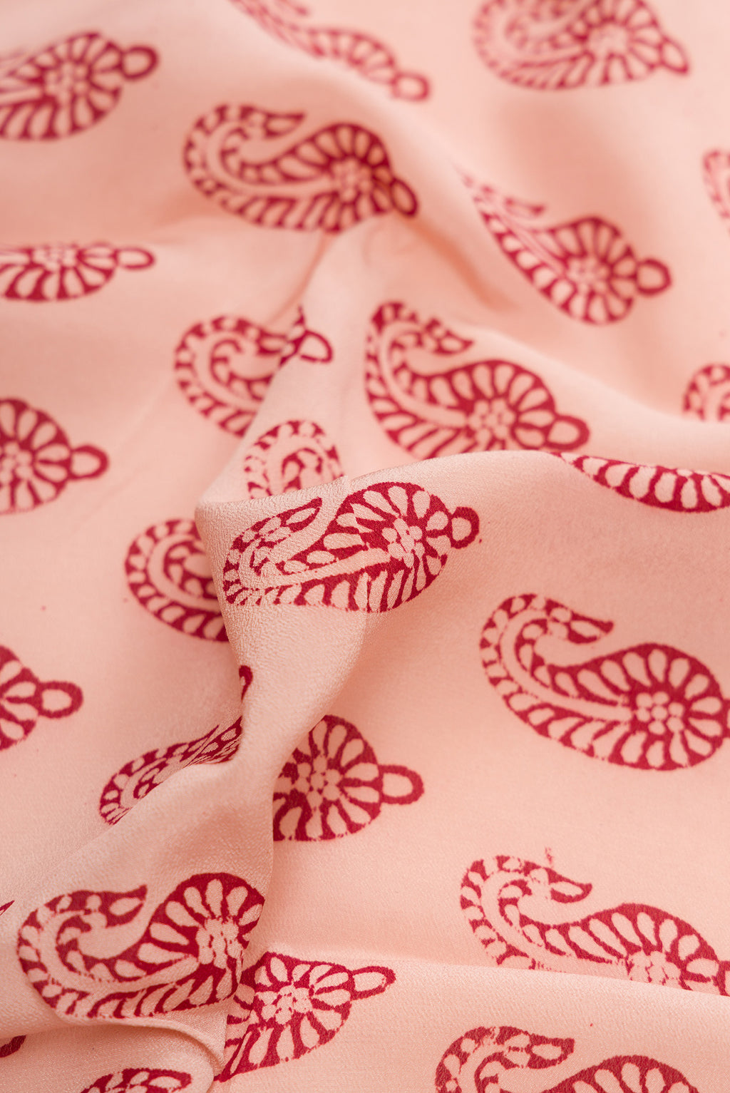 Close up of Rose Gold Dual Tone Mysore Crepe Saree with Printed design on the body and Printed Border.  displaying folds