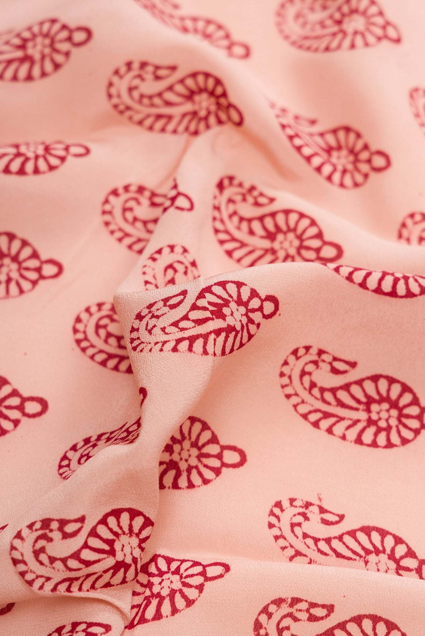 Close up of Rose Gold Dual Tone Mysore Crepe Saree with Printed design on the body and Printed Border.  displaying folds