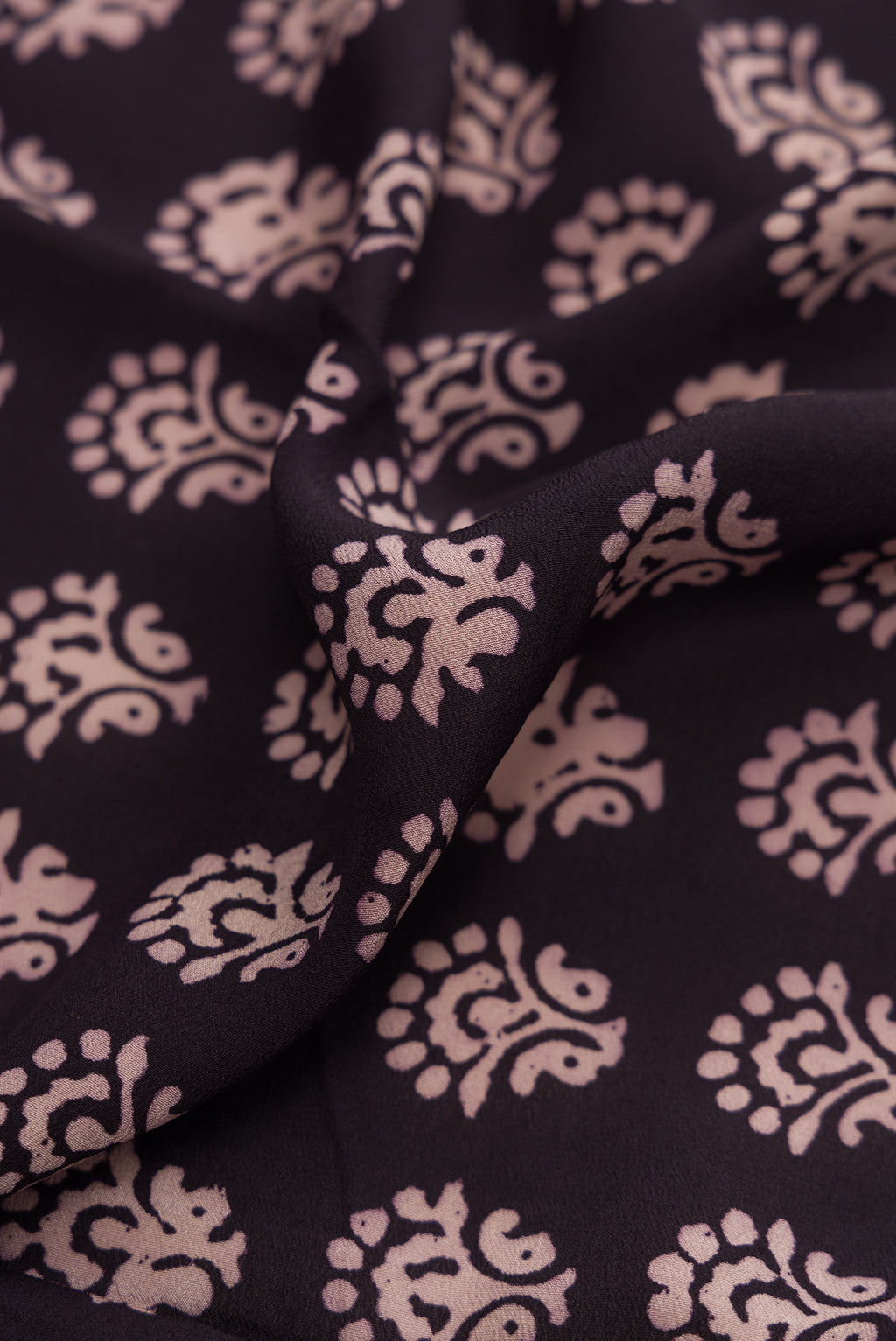 Close up of Coffee Brown Dual Tone Mysore Crepe Saree with Printed design on the body and Printed Border.  displaying folds