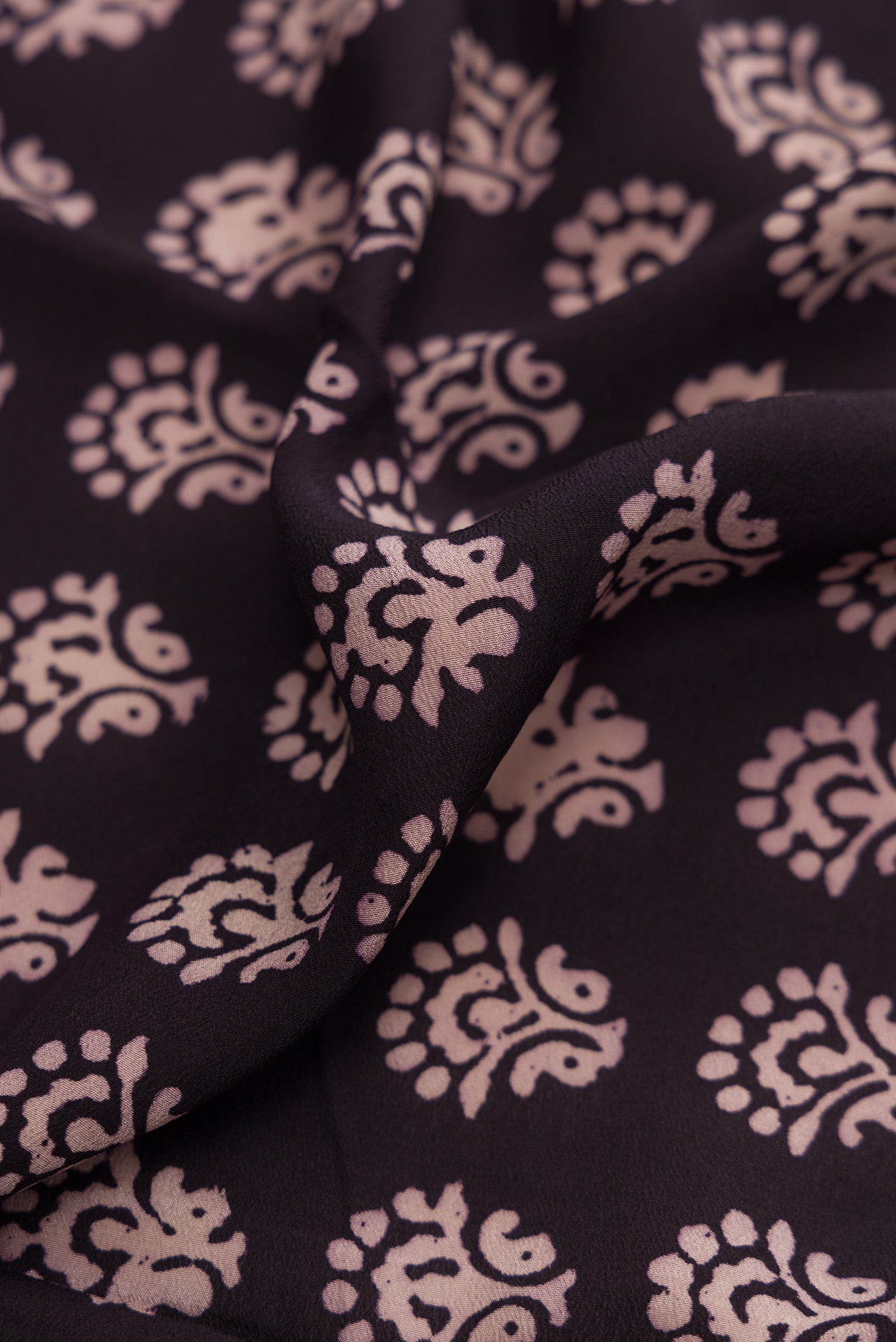 Close up of Coffee Brown Dual Tone Mysore Crepe Saree with Printed design on the body and Printed Border.  displaying folds