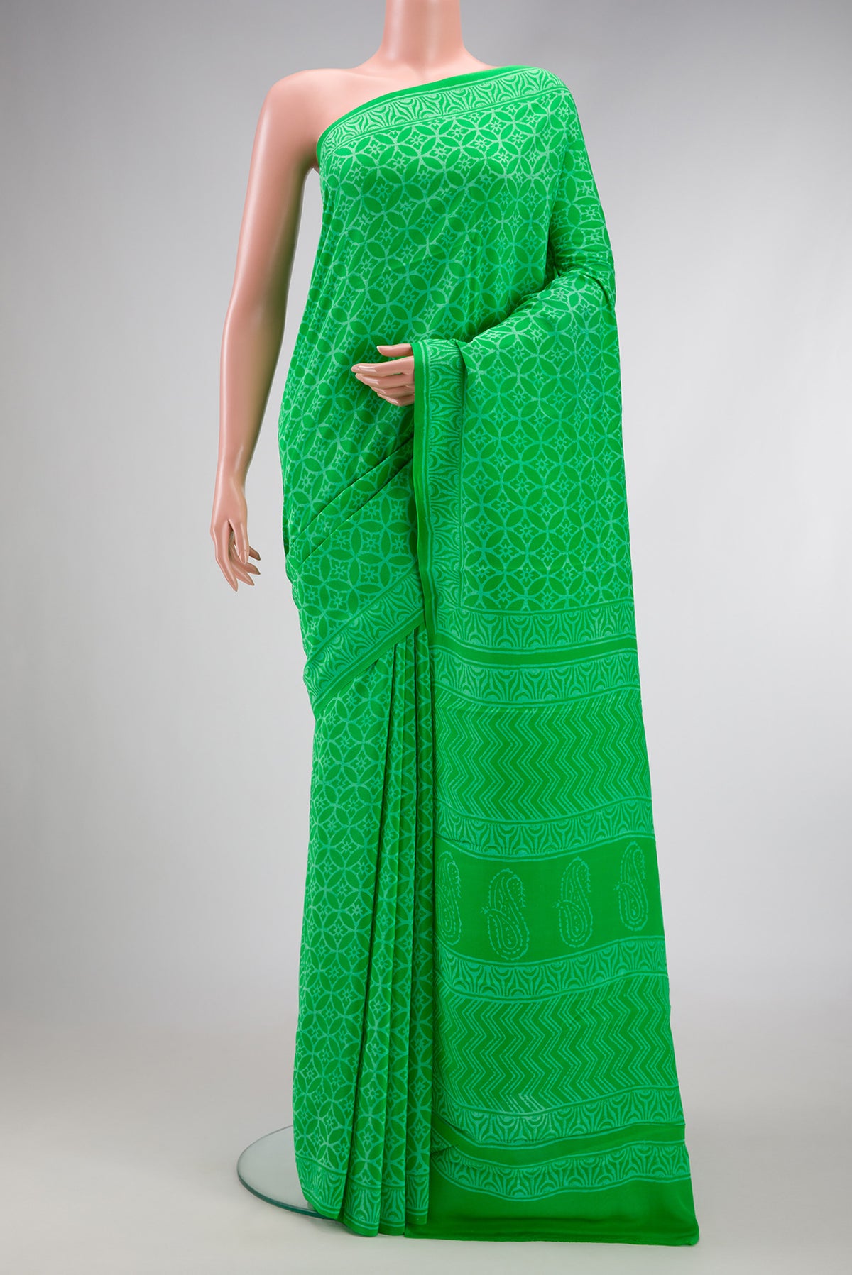 Parrot Green Dual Tone Mysore Crepe Saree with Printed design on the body and Printed Border.  displayed on a mannequin