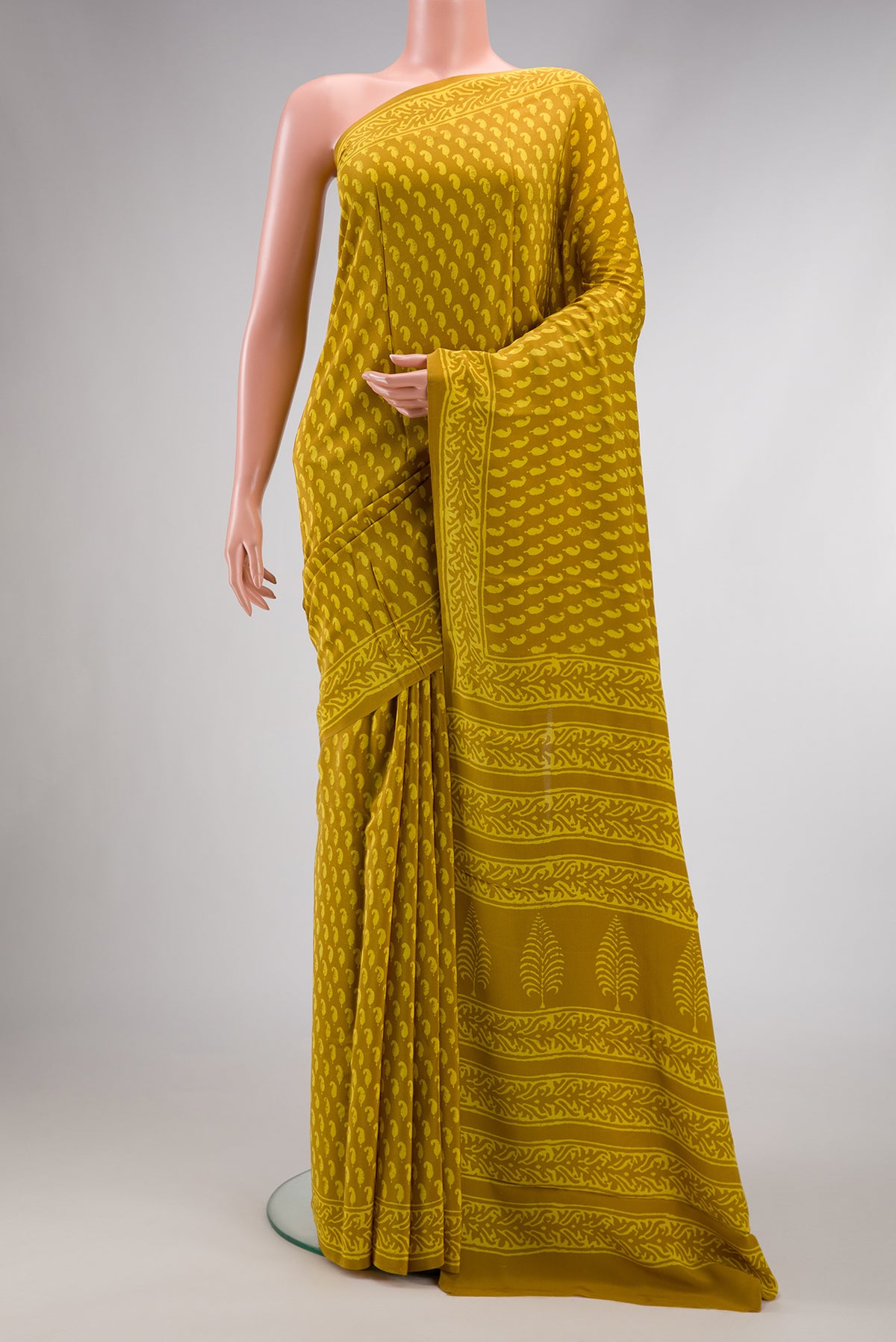 Mustard Dual Tone Mysore Crepe Saree with Printed design on the body and Printed Border.  displayed on a mannequin