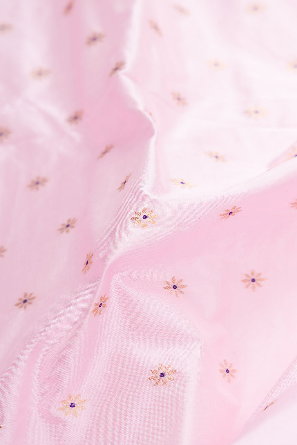 Close up of Pink Dual Tone Paithani Silk Saree with Zari Butta on the body and Paithani Border.  displaying folds