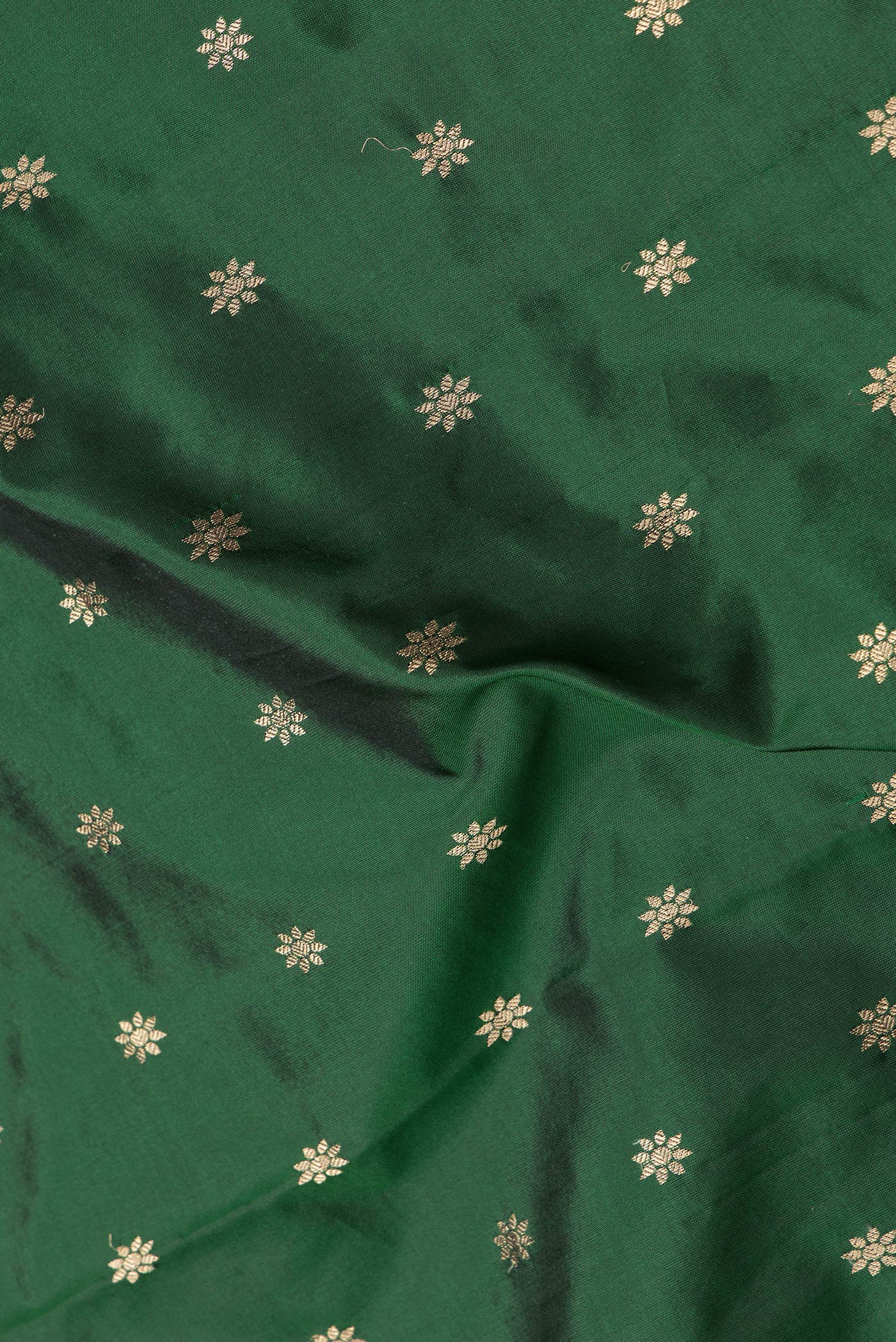 Close up of Bottle Green Dual Tone Paithani Silk Saree with Zari Butta on the body and Zari Border.  displaying folds