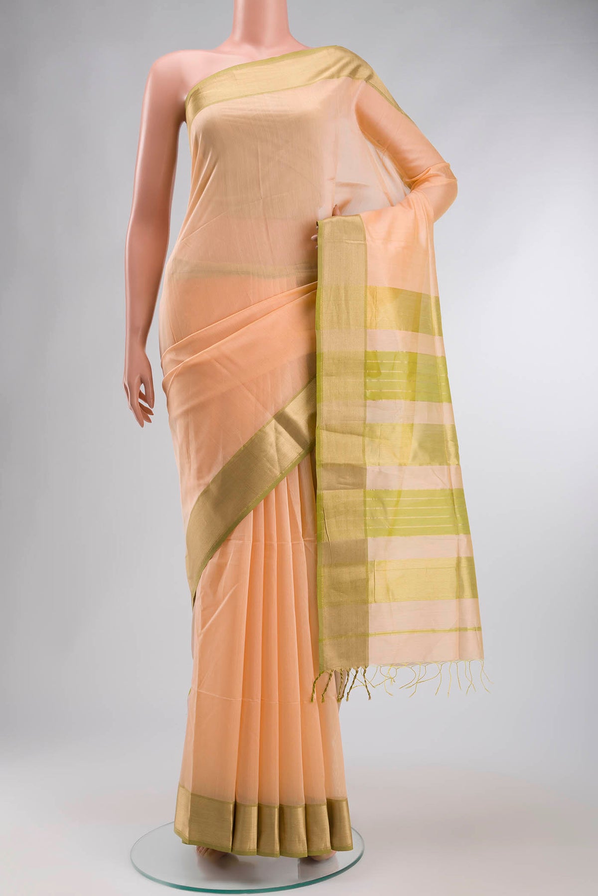 Peach Maheshwari Silk Cotton Saree with Plain Body and Zari Border displayed on a mannequin