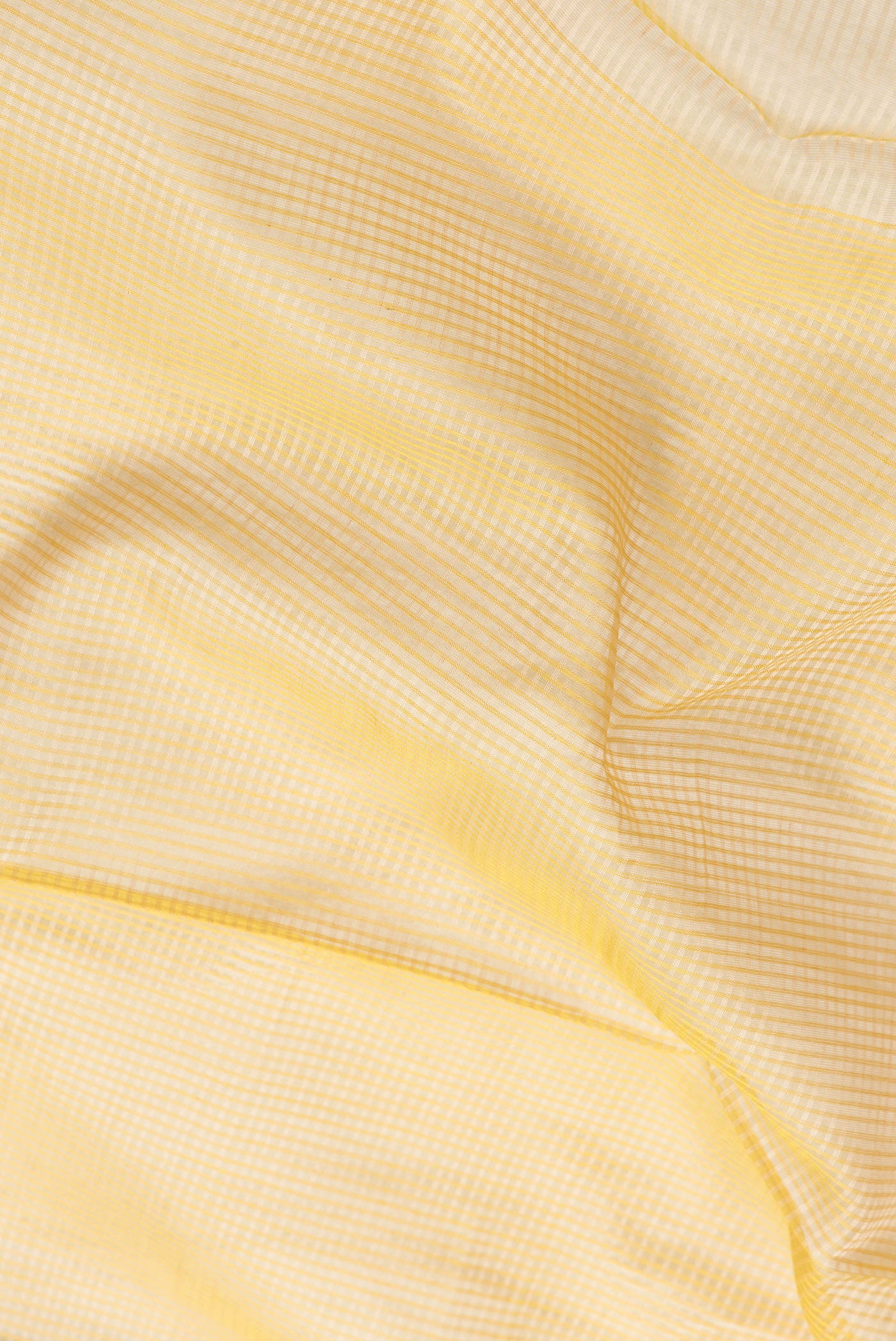 Close up of Beige Dual Tone Maheshwari Silk Saree with Stripes on the body and Zari Border.  displaying folds