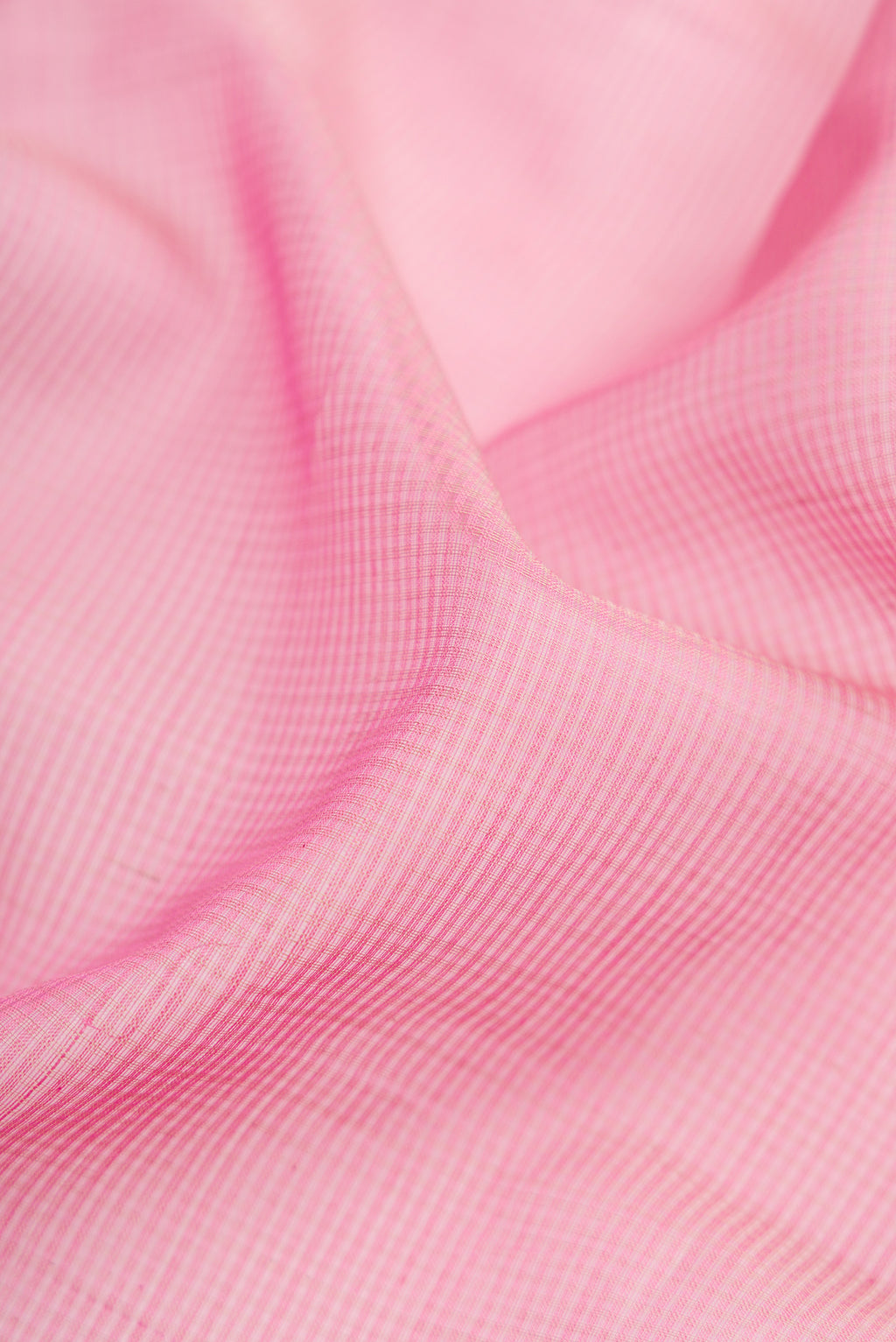 Close up of Pink Dual Tone Maheshwari Silk Cotton Saree with Stripes on the body and Zari Border.  displaying folds