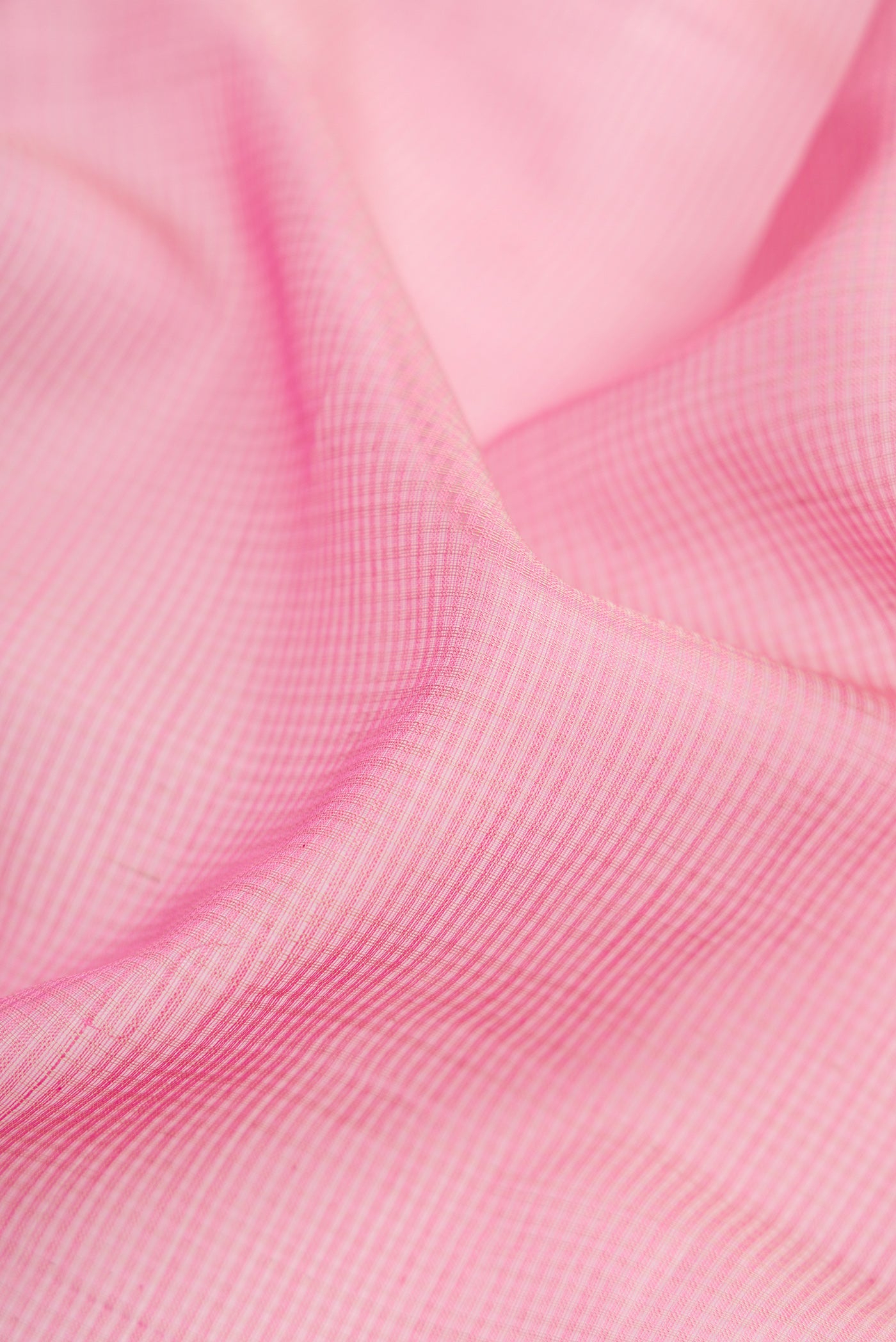 Close up of Pink Dual Tone Maheshwari Silk Cotton Saree with Stripes on the body and Zari Border.  displaying folds