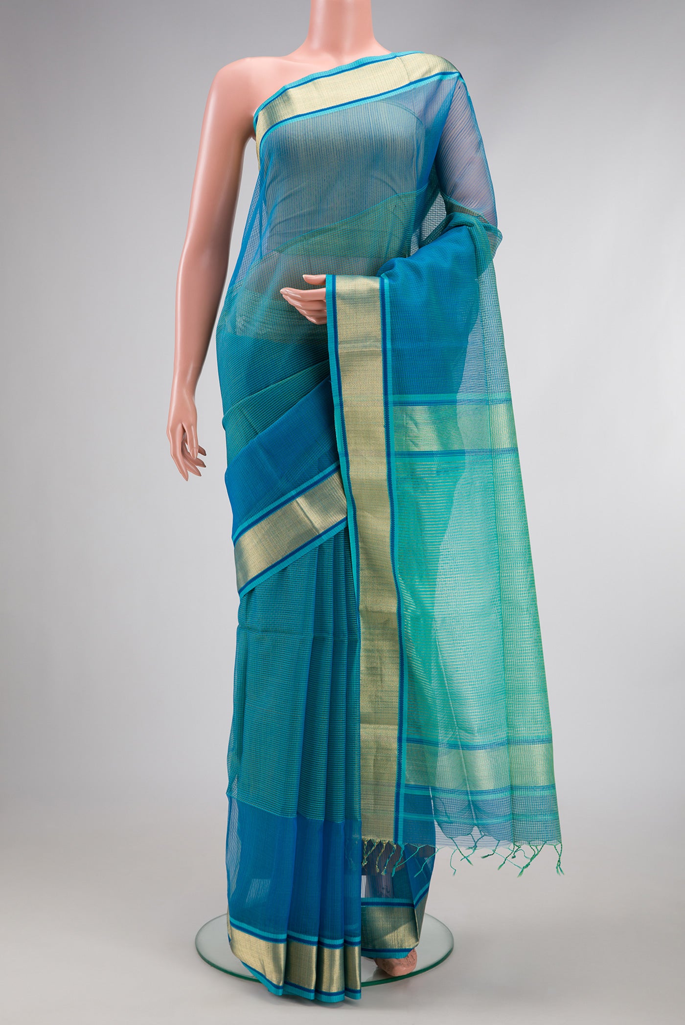 Peacock Blue Dual Tone Maheshwari Silk Cotton Saree with Checked design on the body and Zari Border.  displayed on a mannequin