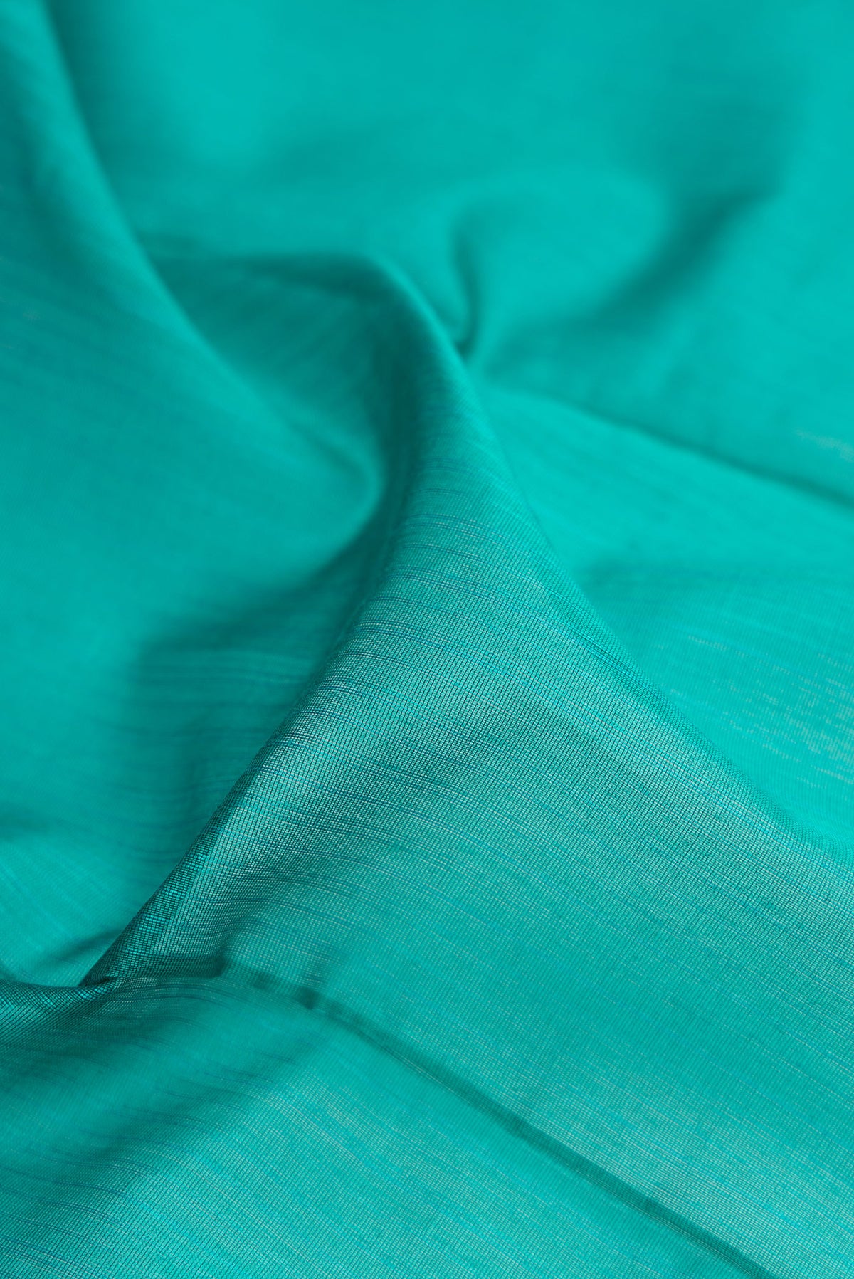 Close up of Turquoise Dual Tone Maheshwari Silk Cotton Saree with Stripes on the body and Zari Border.  displaying folds