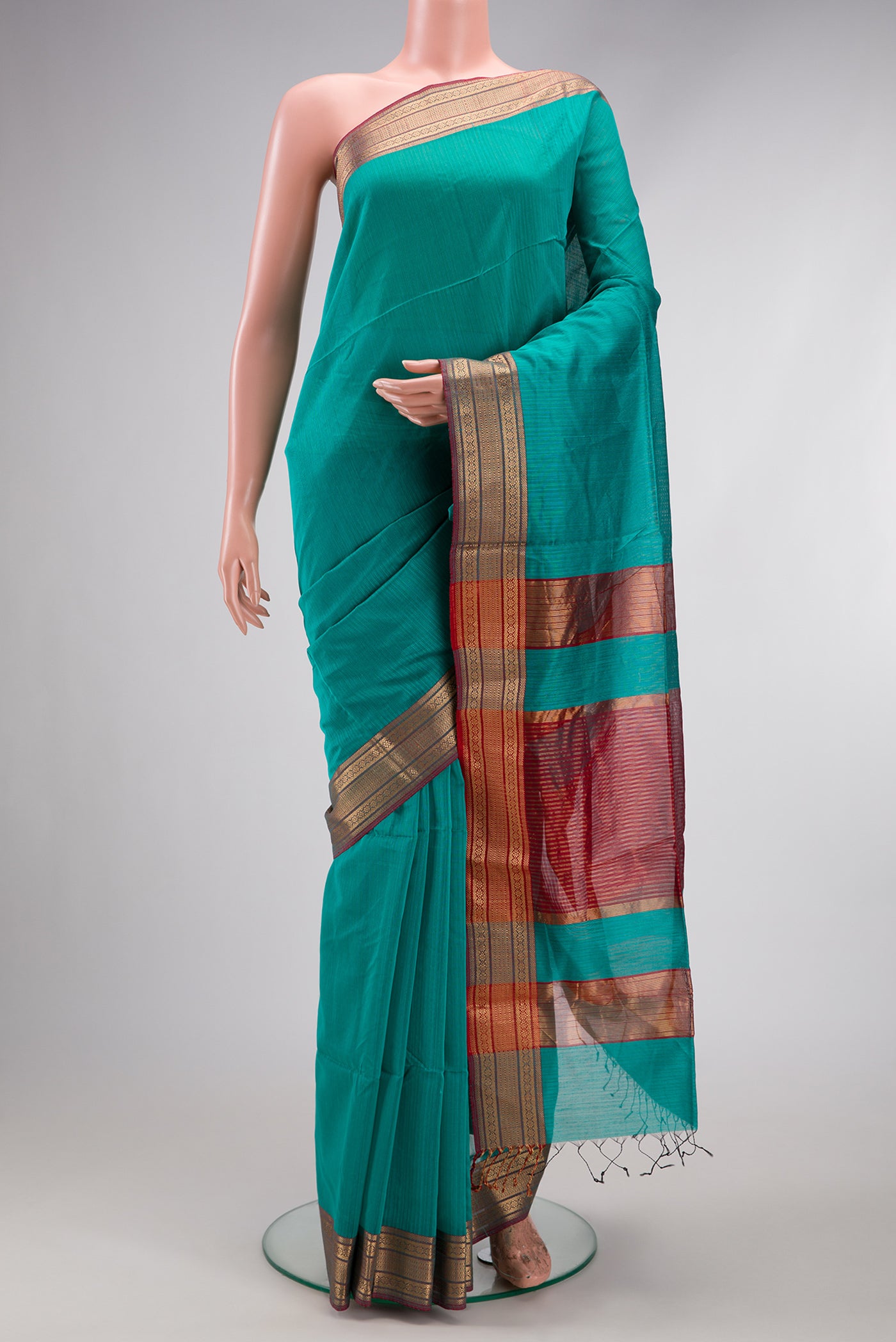 Turquoise Dual Tone Maheshwari Silk Cotton Saree with Stripes on the body and Zari Border.  displayed on a mannequin