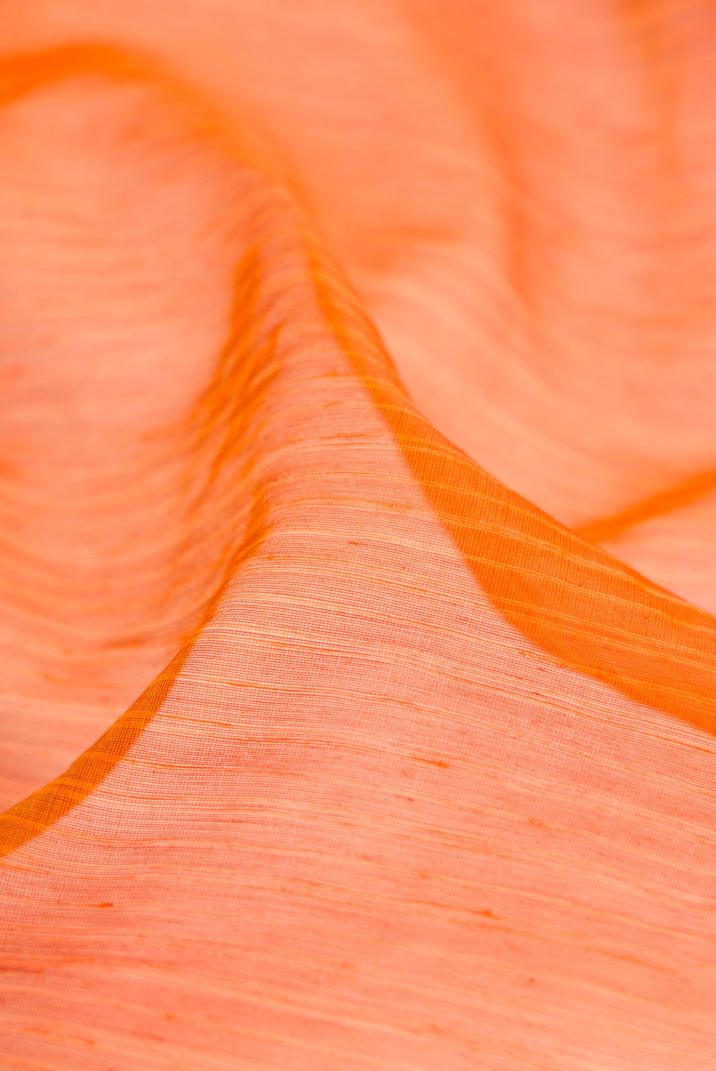 Close up of Mustard Maheshwari Silk Cotton Saree with Stripes on the body and Zari Border.  displaying folds