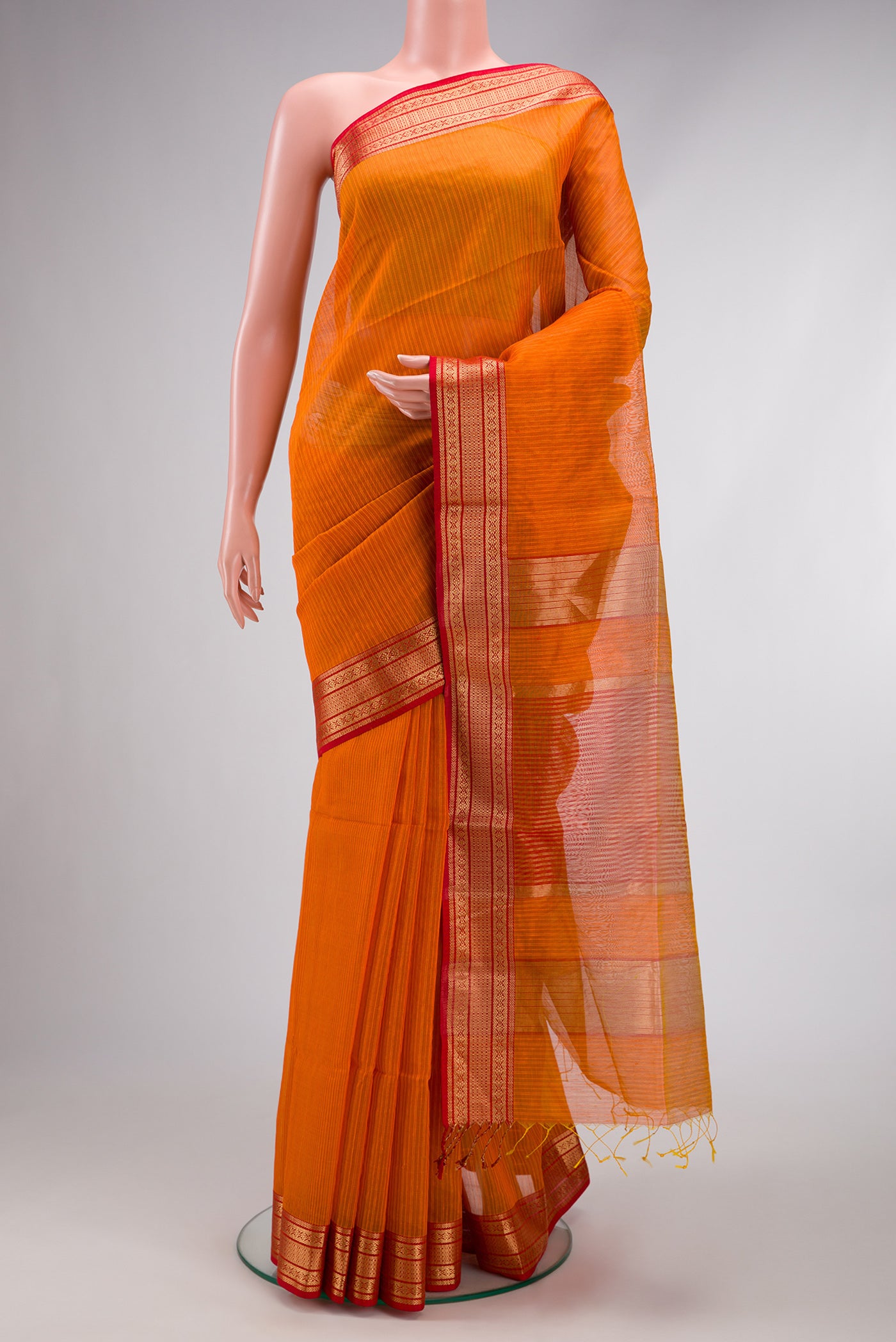 Mustard Maheshwari Silk Cotton Saree with Stripes on the body and Zari Border.  displayed on a mannequin