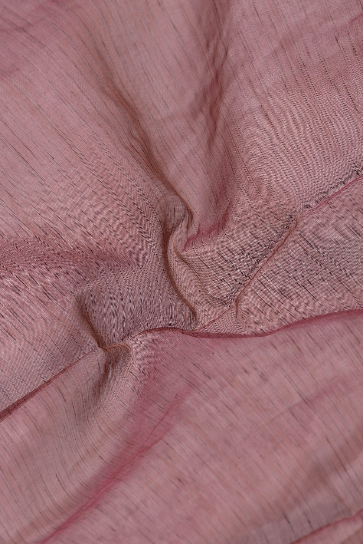 Close up of Maroon Dual Tone Maheshwari Silk Saree with Stripes on the body and Zari Border.  displaying folds