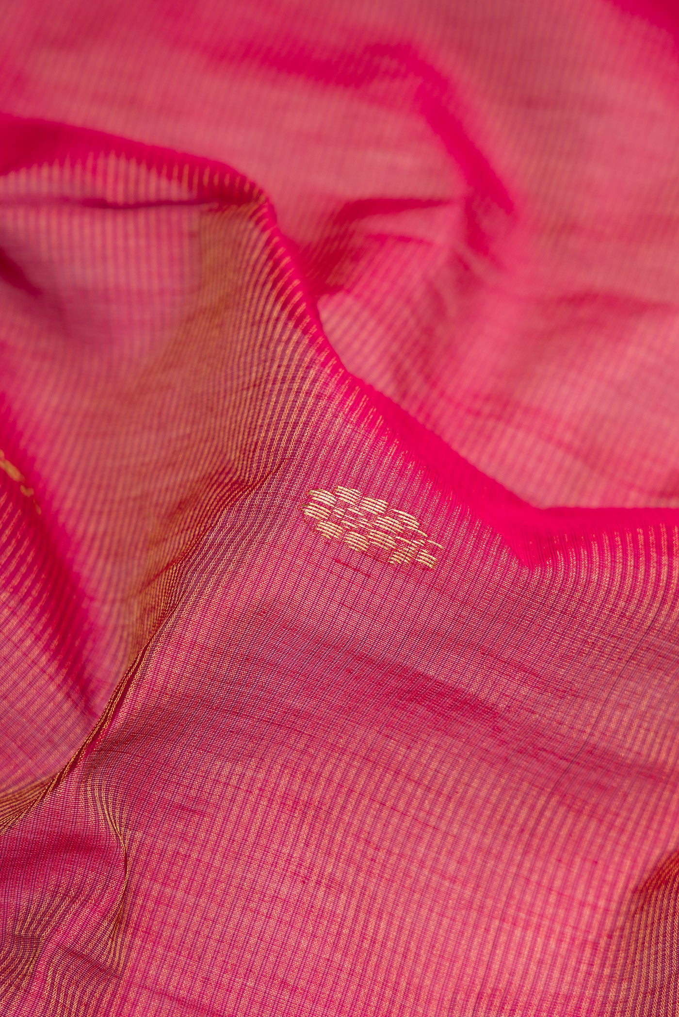 Close up of Rani Pink Dual Tone Maheshwari Silk Saree with Stripes on the body and Zari Border.  displaying folds