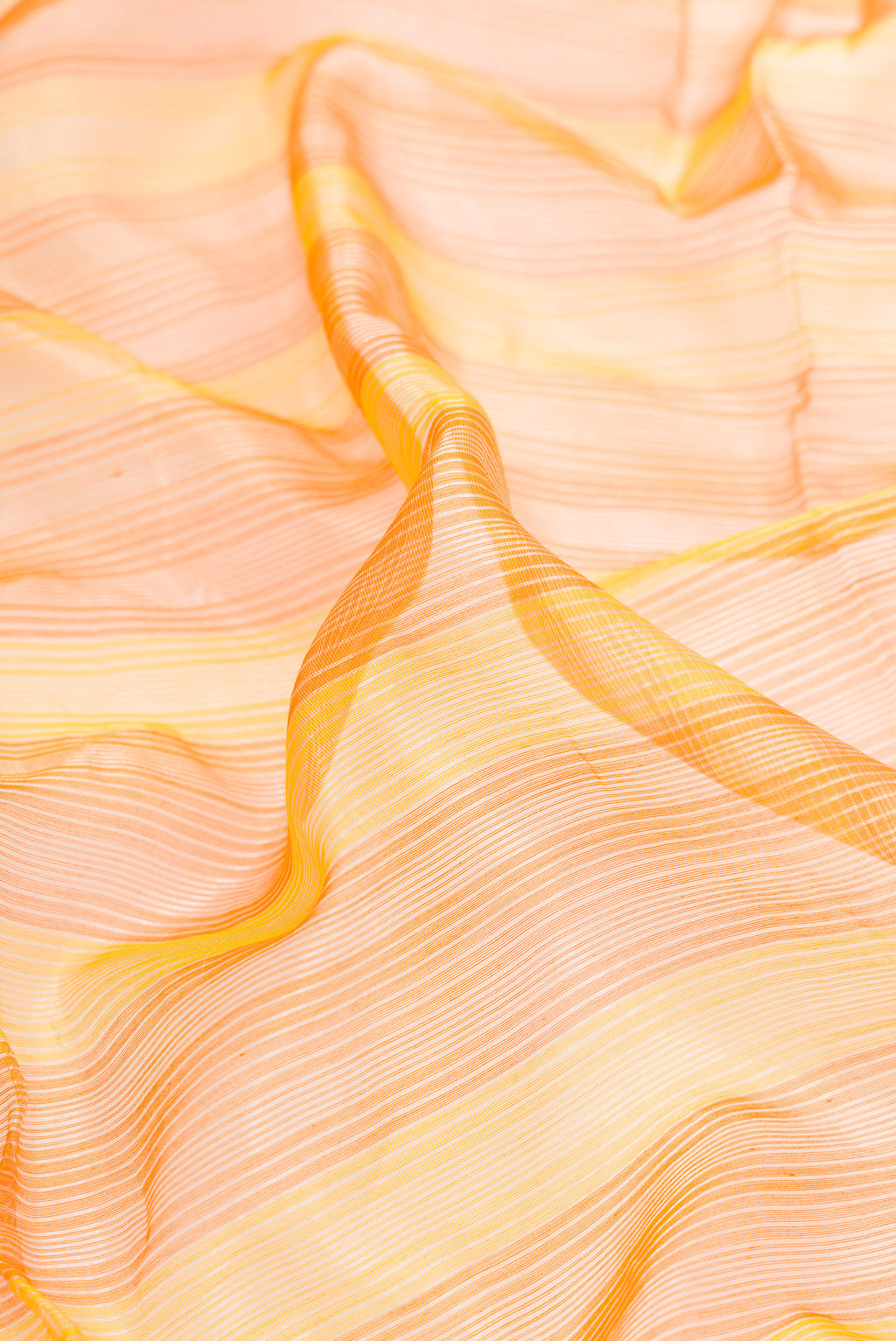 Close up of Orange and Yellow Color Maheshwari Silk Saree with Stripes on the body and Zari Border.  displaying folds