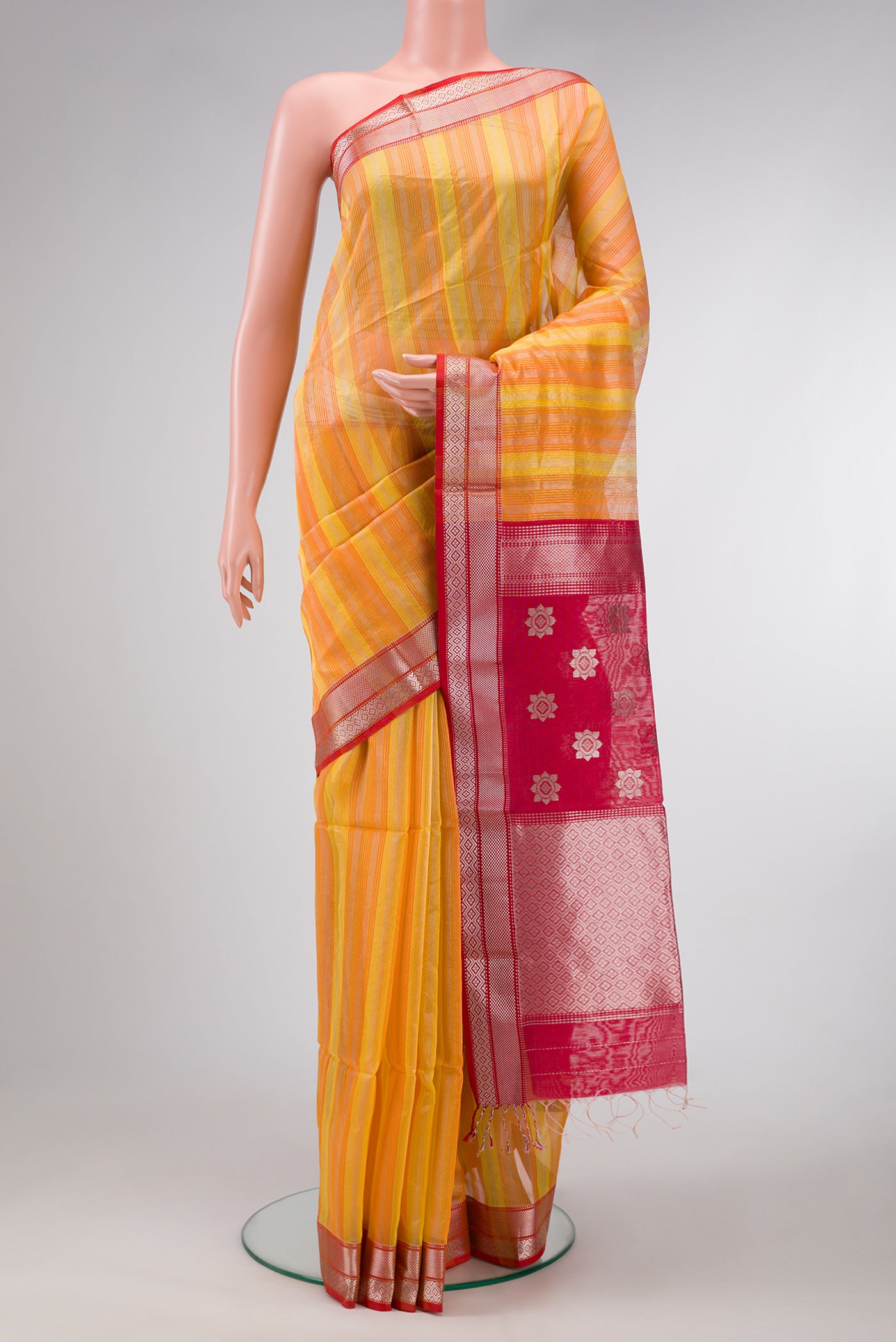 Orange and Yellow Color Maheshwari Silk Saree with Stripes on the body and Zari Border.  displayed on a mannequin