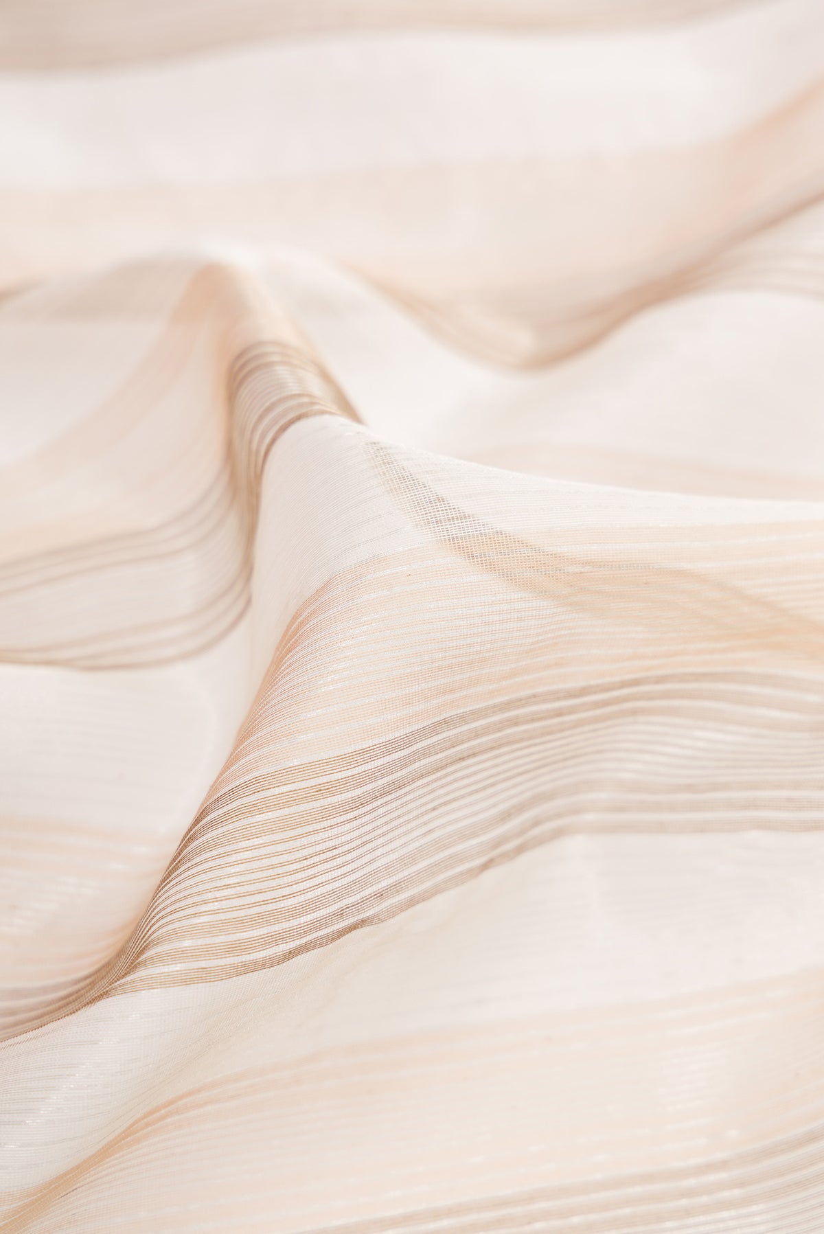 Close up of Dark Beige Dual Tone Maheshwari Silk Cotton Saree with Stripes on the body and Zari Border.  displaying folds