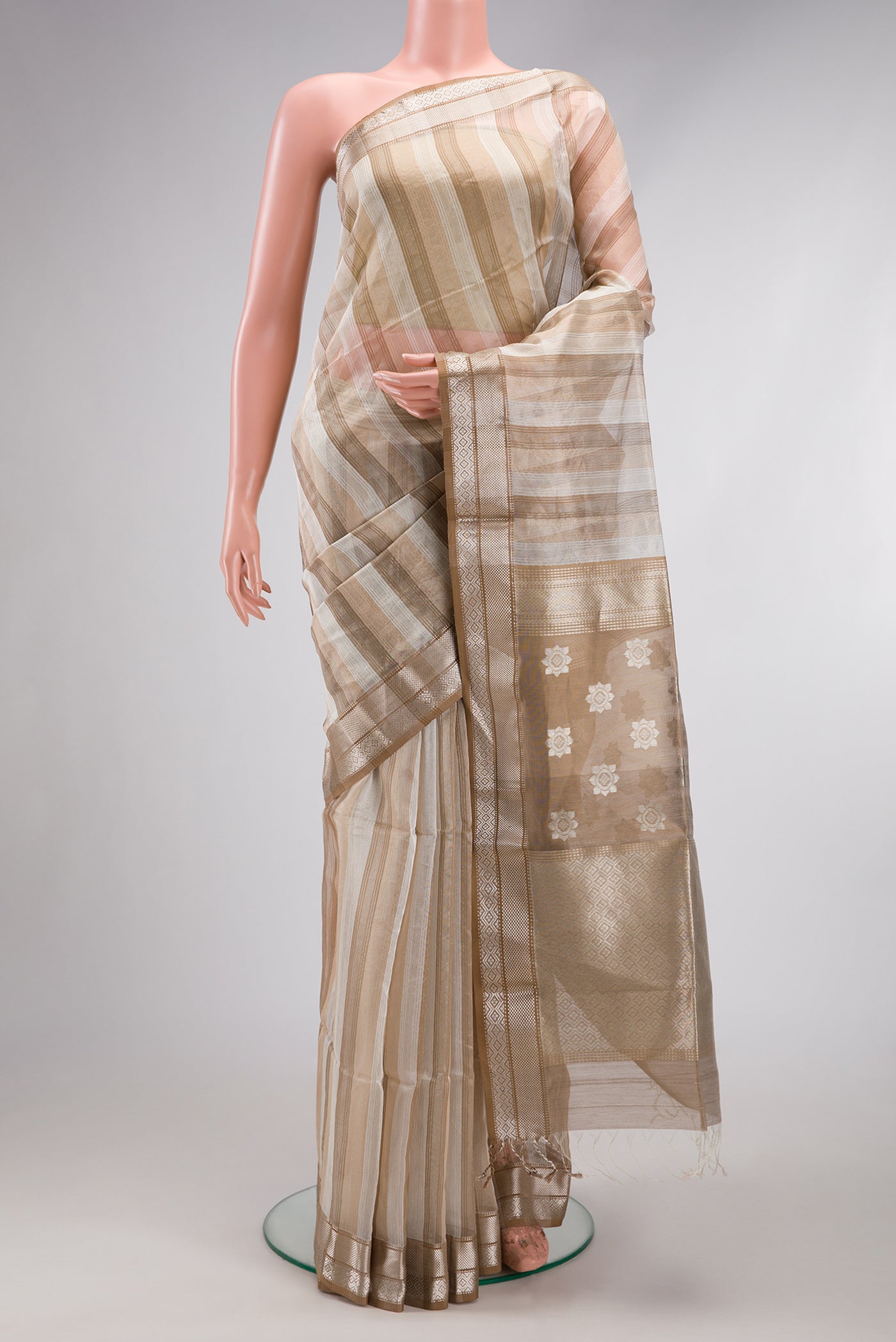 Dark Beige Dual Tone Maheshwari Silk Cotton Saree with Stripes on the body and Zari Border.  displayed on a mannequin