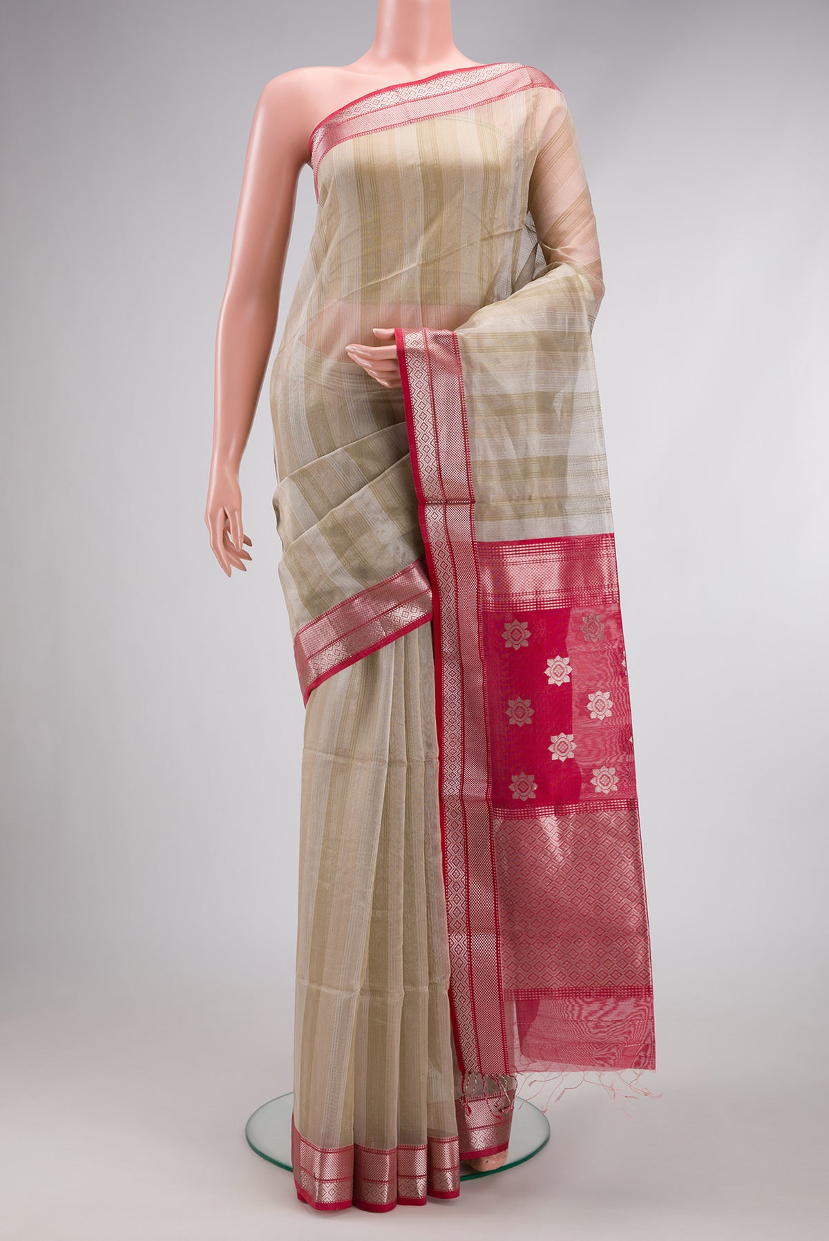 Dark Beige Dual Tone Maheshwari Silk Cotton Saree with Stripes on the body and Zari Border.  displayed on a mannequin
