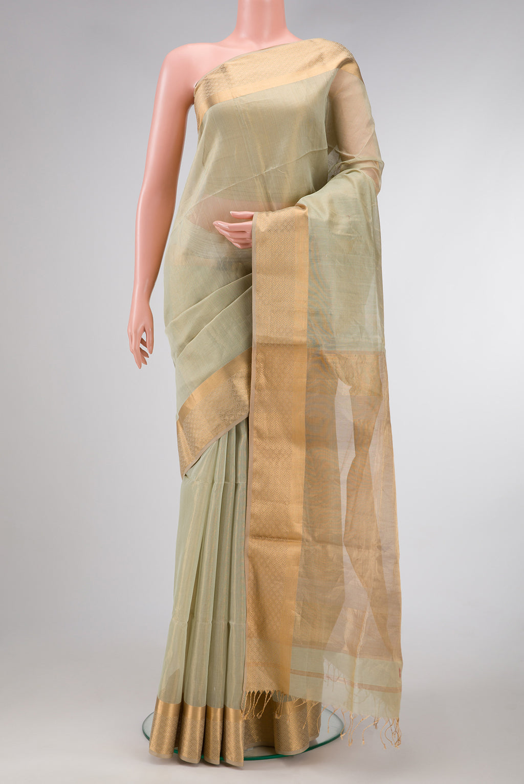 Pista Green Dual Tone Maheshwari Tissue Silk Saree with Plain Body and Zari Border.  displayed on a mannequin