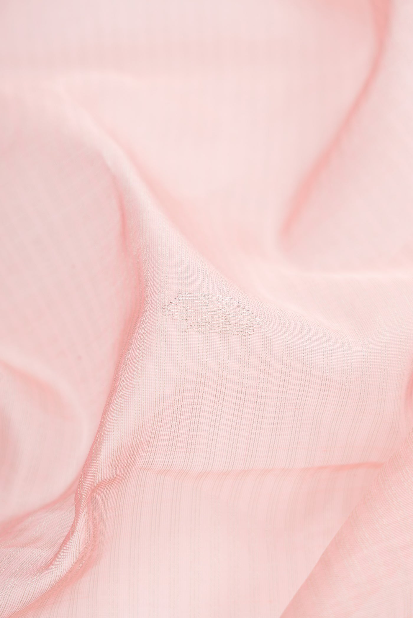 Close up of Pink Dual Tone Maheshwari Silk Cotton Saree with Zari Butta on the body and Zari Border.  displaying folds