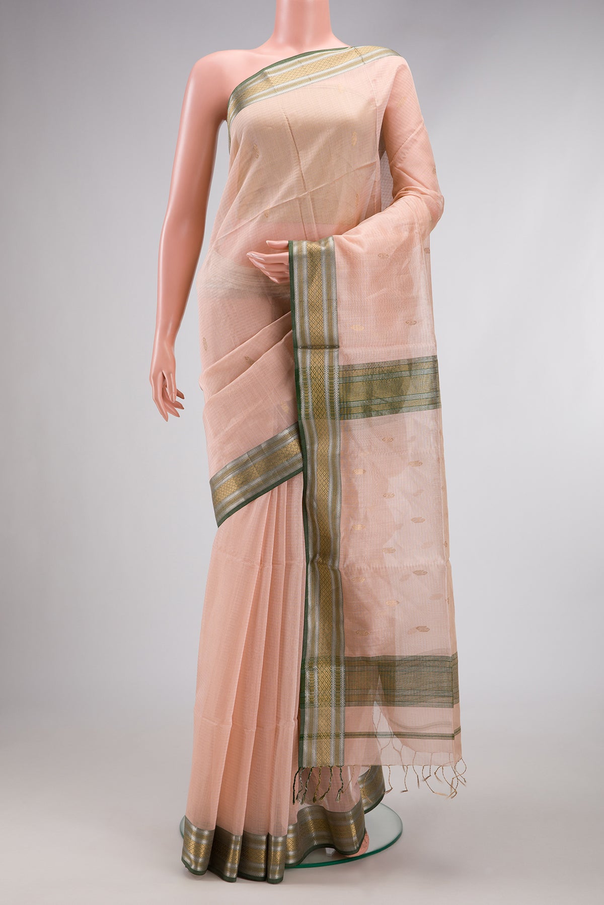 Rose Gold Dual Tone Maheshwari Silk Cotton Saree with Stripes on the body and Zari Border.  displayed on a mannequin