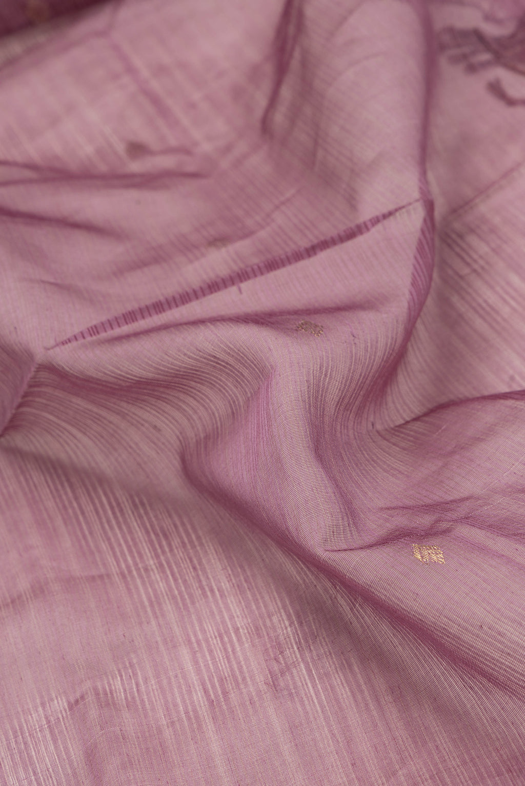 Close up of Pink Dual Tone Maheshwari Silk Saree with Stripes on the body and Zari Border.  displaying folds