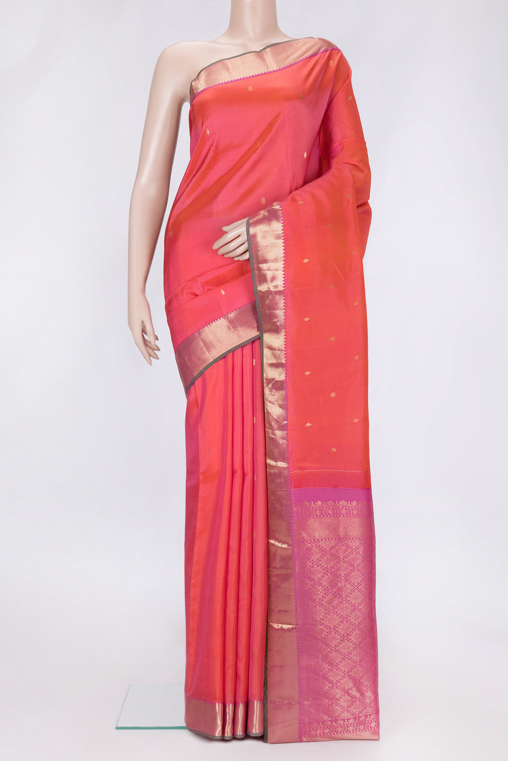 Peach Dual Tone Kanjivaram Silk Saree with Zari Butta on the body and Zari Border.  displayed on a mannequin