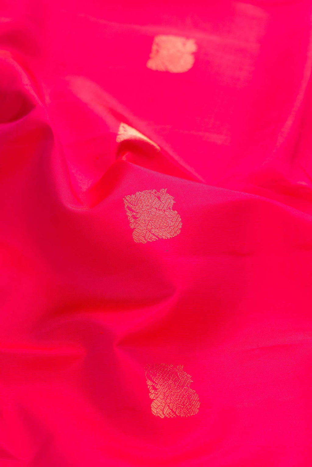 Close up of Pink with Orange Color Kanchipuram Silk Saree with Zari Butta on the body and Zari Border displaying folds